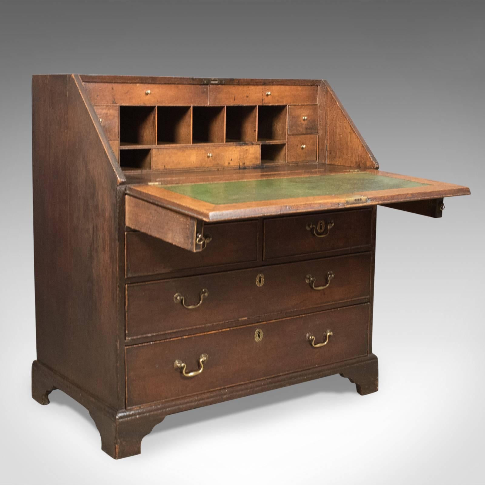 This is an antique bureau, an English oak desk from the Georgian period in the early 18th century, circa 1720.

Highly desirable with rare and unusual drawers so well hidden.

Warm hues of English oak displaying wisps of medullary