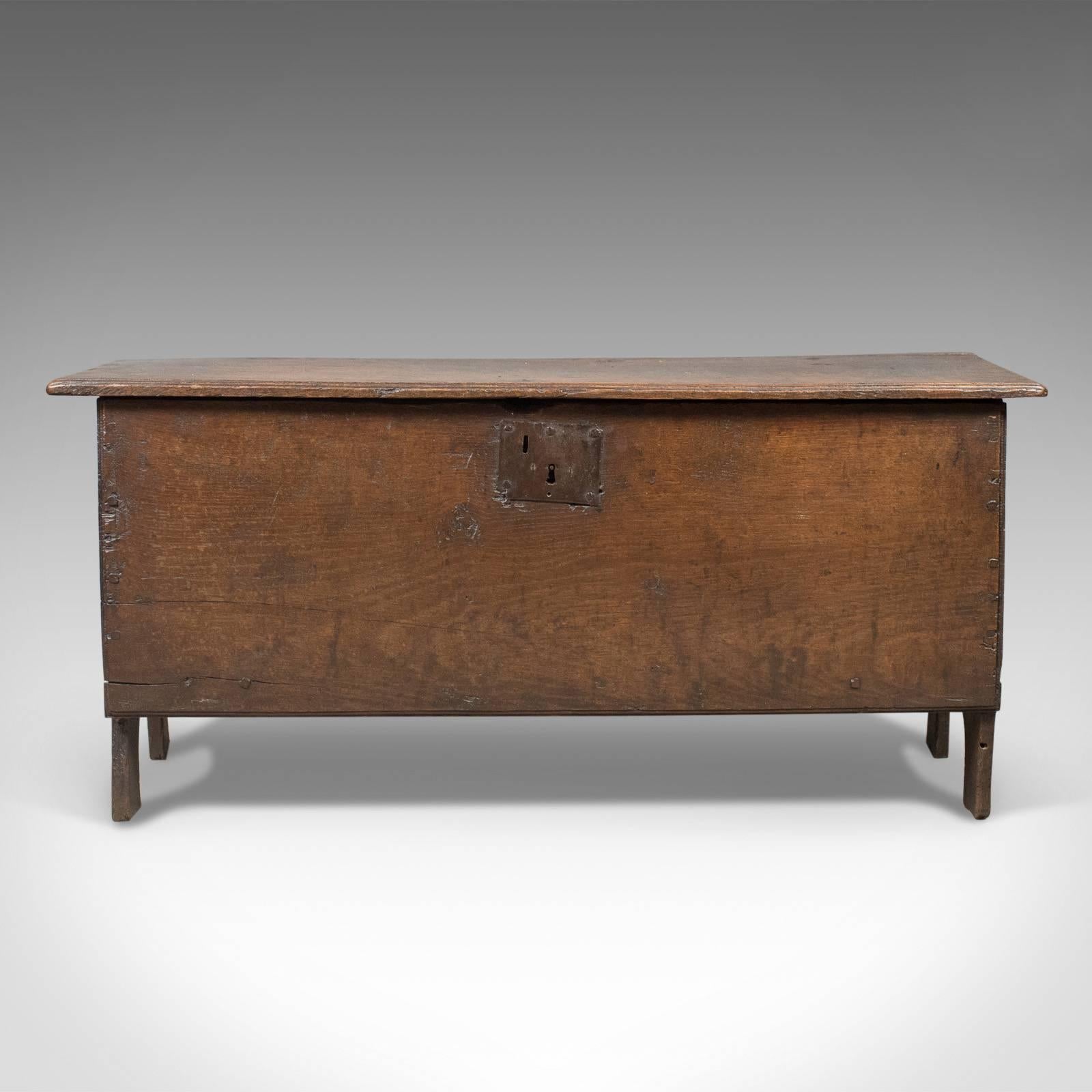 This is an antique coffer, an English 6 plank sword chest in oak dating to the late 17th century circa 1680.

Classic six board construction
English oak with desirable aged patina
Raised on extended stiles with arched 'mouse hole'