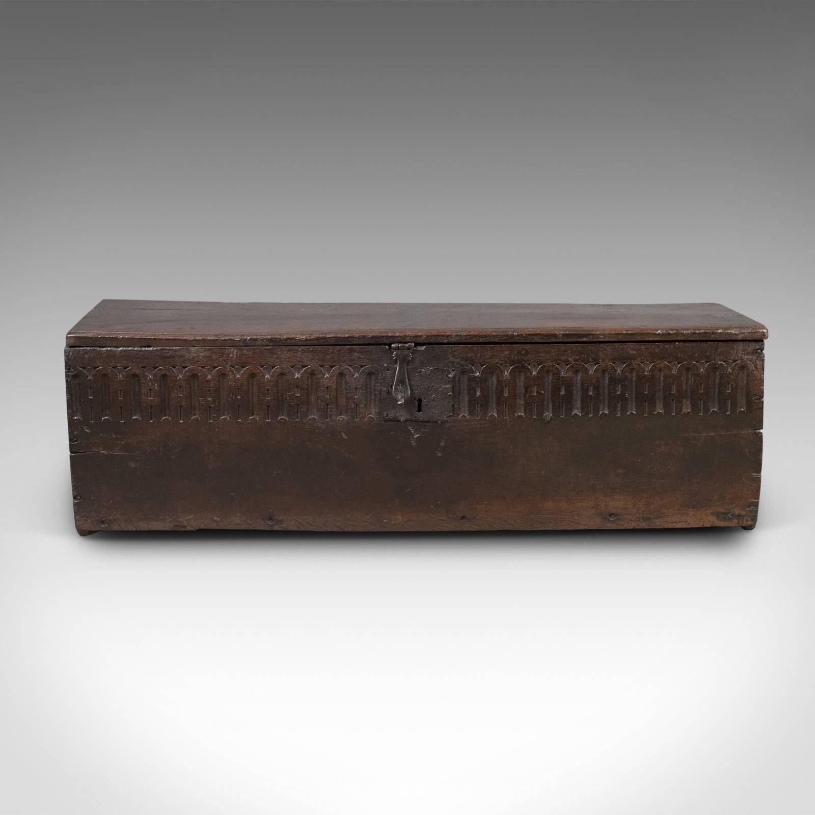 This is an antique coffer in oak, a six plank sword chest. English, dating to the mid-17th century, circa 1660.

Robust six board construction
English oak with desirable aged patina
Front board decorated with colonnade carving

Handcrafted