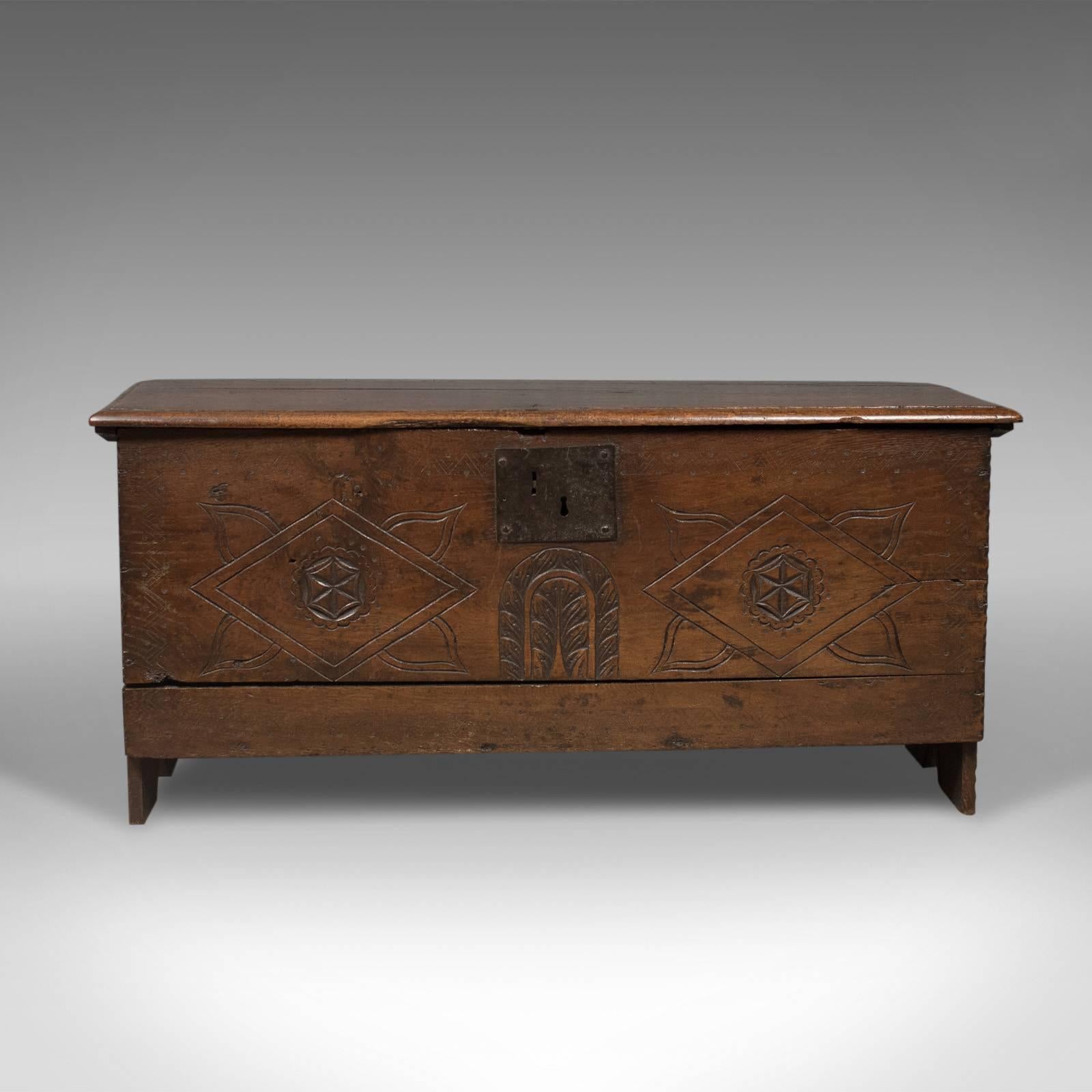 This is an antique coffer, a six plank sword chest in English oak dating to the 17th century, circa 1670.

Classic six board construction
English oak with desirable aged patina
Raised on extended stiles to the ends

Facing board decorated with