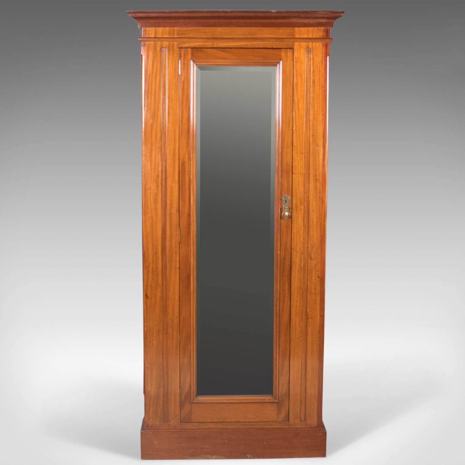 This is an Victorian antique corner wardrobe in mahogany. An English cabinet dating to circa 1880.

Quality craftsmanship in mahogany displaying honey tones
Good, consistent color and grain interest in the wax polished finish
Upper frieze