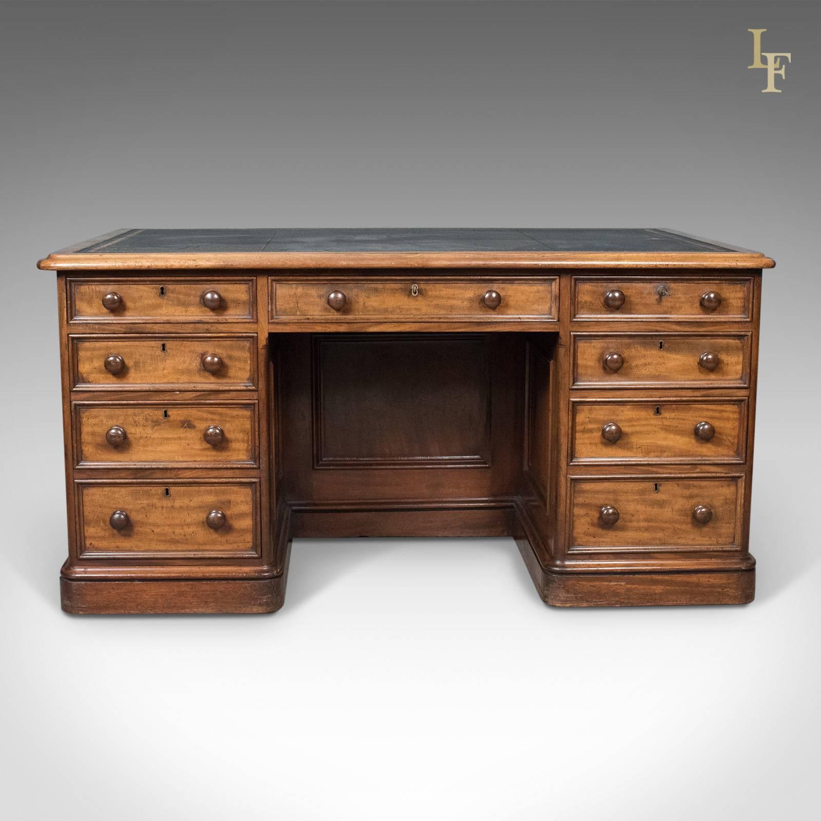 This is a large antique pedestal desk. An English piece in mahogany and dating to the mid-Victorian period, circa 1860.

Superior quality in country house proportion
Highly desirable natural aged coloration and patina
Professionally fitted,