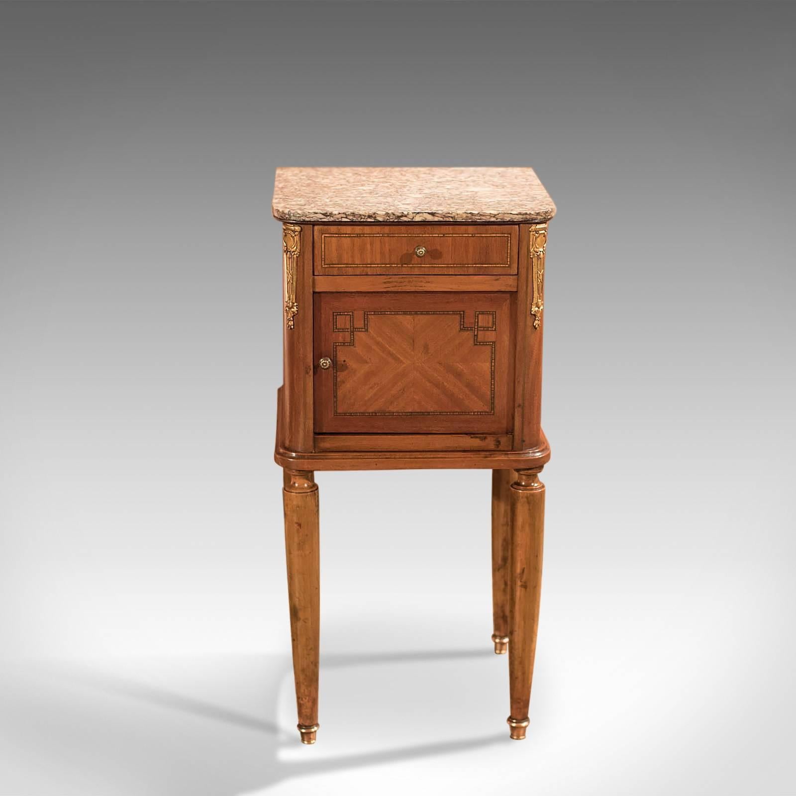 This is an antique bedside table, a mahogany pot cupboard, or nightstand, dating to the end of the 19th century.

Raised on turned, tapered fruitwood legs. The feet capped in polished bronze shoes, this fine example of a Victorian pot cupboard has