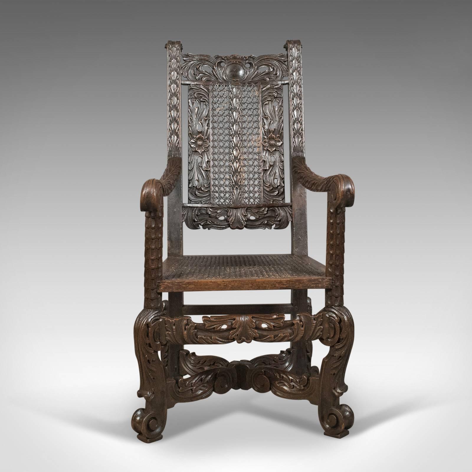 This is an antique armchair, a Victorian carved side or hall chair in English oak dating to circa 1880.

Profusely carved displaying the Victorian propensity for excess
Extraordinary scrolled feet to acanthus leaf spurs
United by a scroll carved