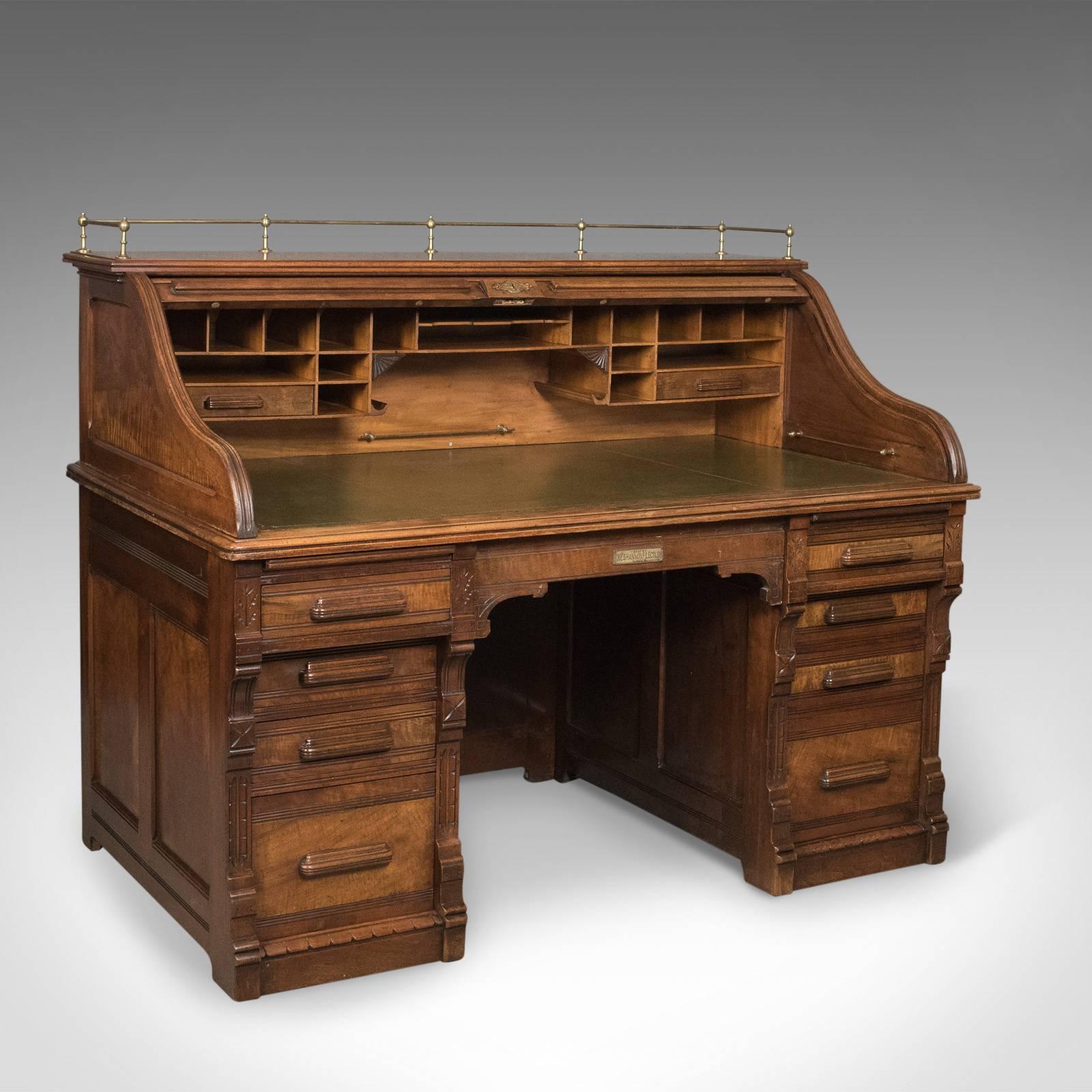 This is an antique roll top desk in English walnut by the Shannon File Co., London, Edwardian dating to circa 1900. 

A very fine example with a show back – ideal for centre room placement
English walnut displaying good consistent color with a