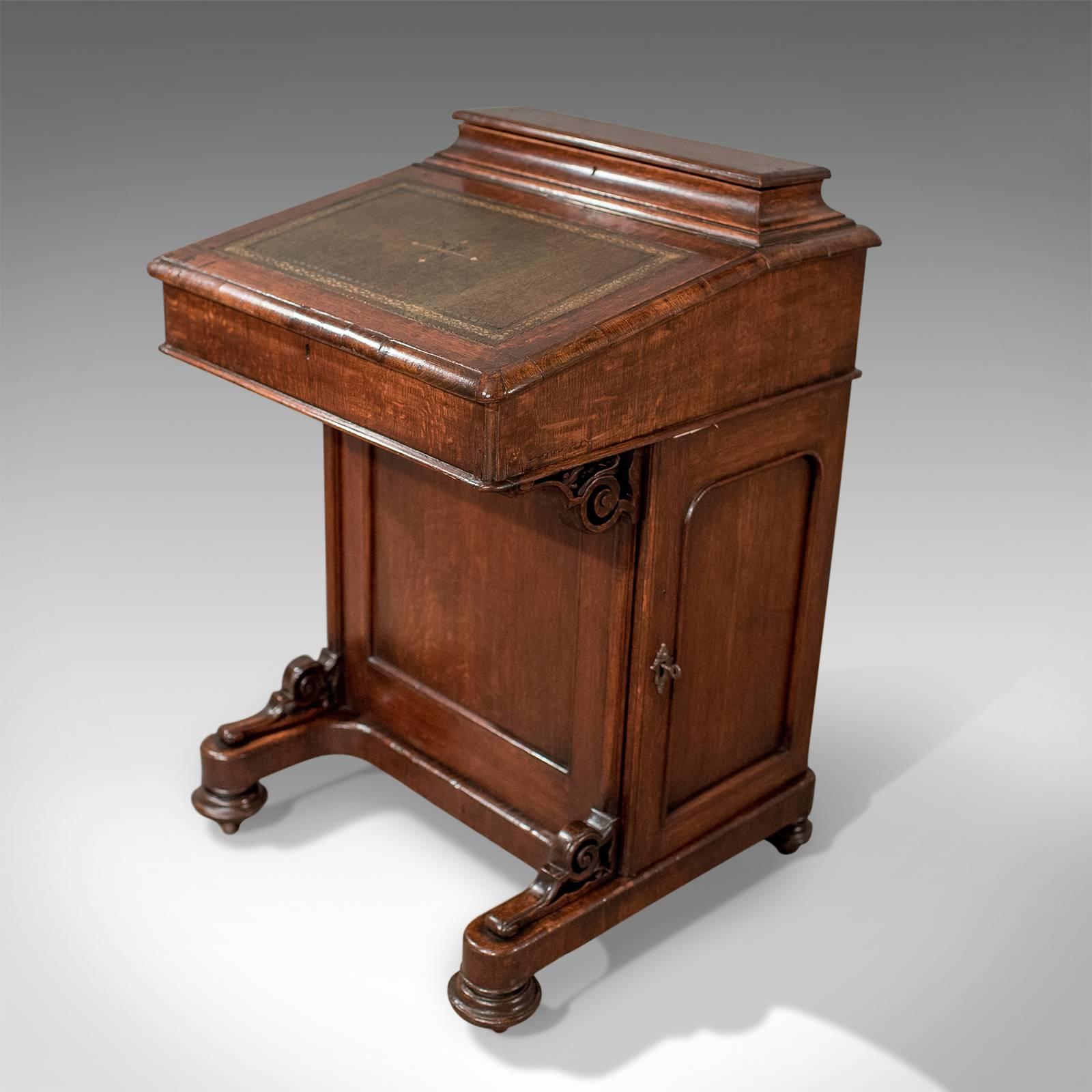 This is a Victorian antique Davenport in English oak. A small writing desk bureau, dating to circa 1870.

Attractive grain interest in the oak with medullary rays present
Deep patinated tones to polished wax finish
Contrasting inner with