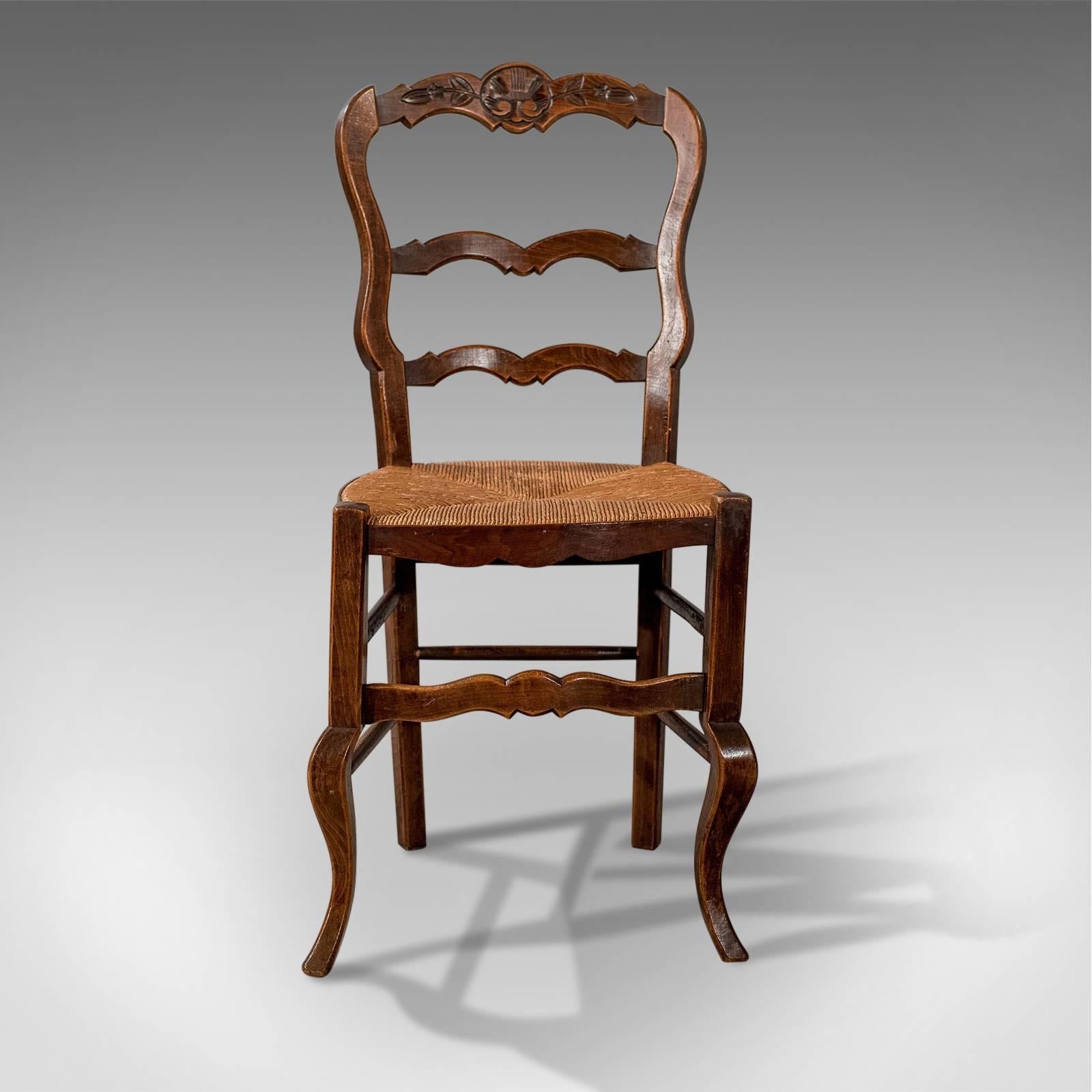 This is a set of four antique dining chairs in dark beech. French country kitchen chairs dating to the late 19th century, circa 1900.

Well crafted country chairs with charm and character
Attractive tones to the dark beech which display good