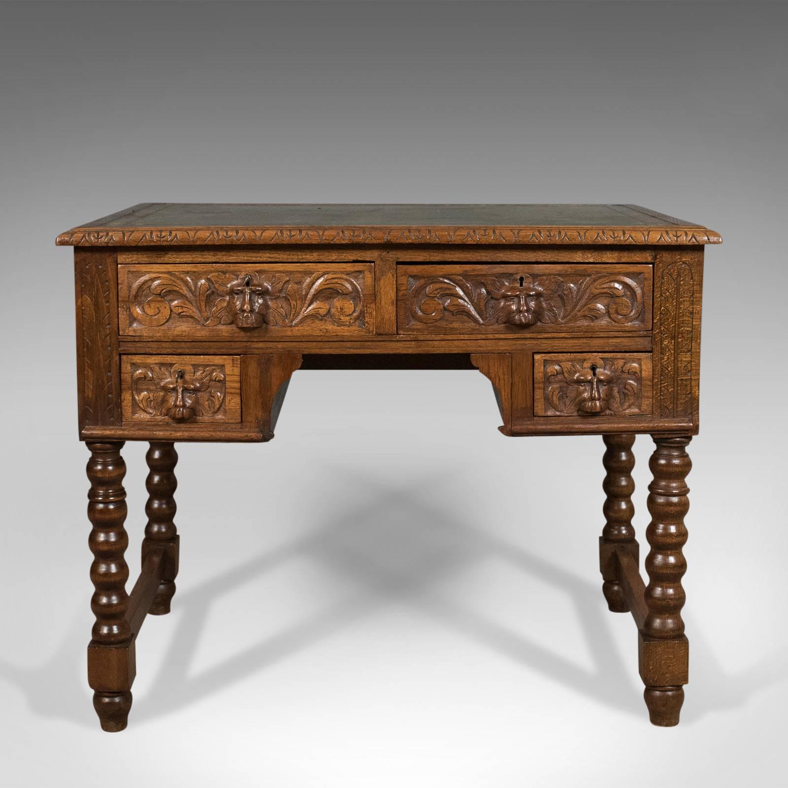 This is an antique, green man lowboy, an English oak, Victorian desk or writing table dating to, circa 1900.

Good color and patina to the English oak
Raised on bobbin turned legs with end stretchers

Well executed carving to the green man
