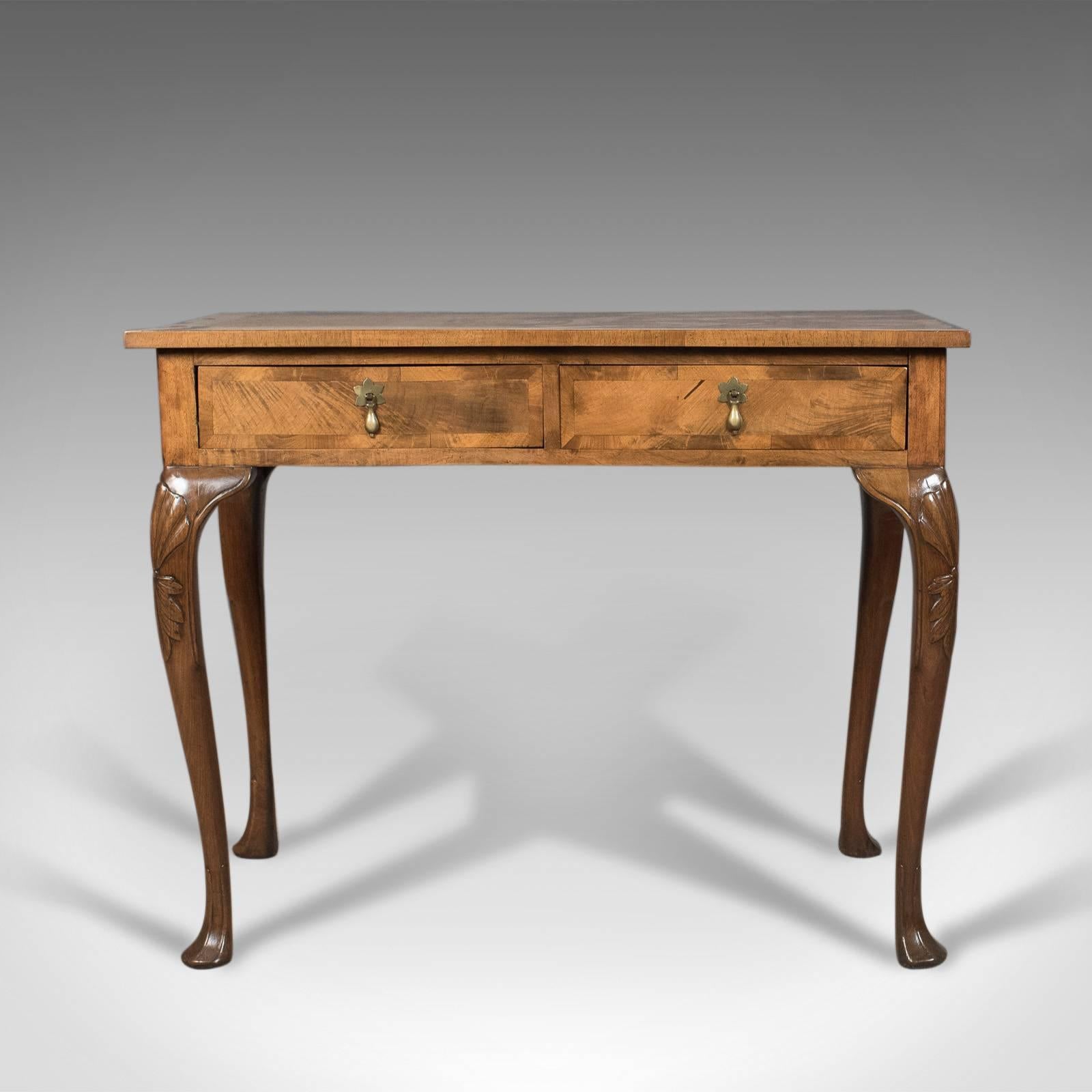 This is an Edwardian antique side table with drawers in English walnut dating to circa 1910.

Desirable light colour to the English walnut
Grain interest notably in the crossbanding to the top and drawer fronts
Well proportioned and of quality