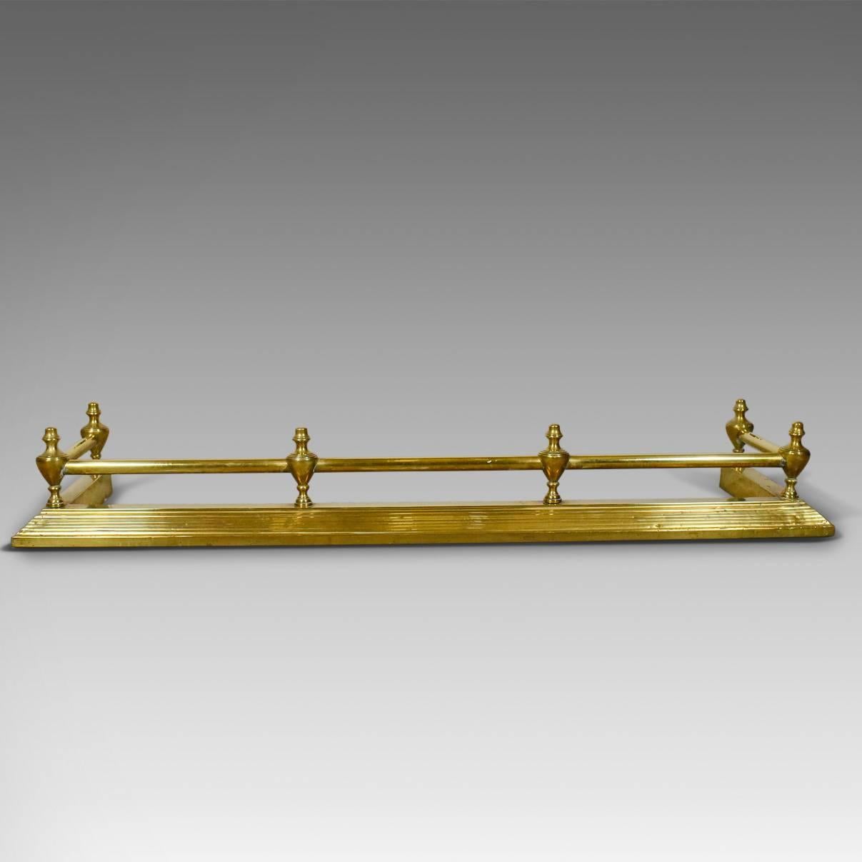This is an antique brass fire kerb, Victorian fireside fender, English, circa 1880.

Attractive fire kerb with classical overtones
The brass mellowed with an aged patina
Stepped plinth rises to gallery
Gallery bar supported by six cast urn