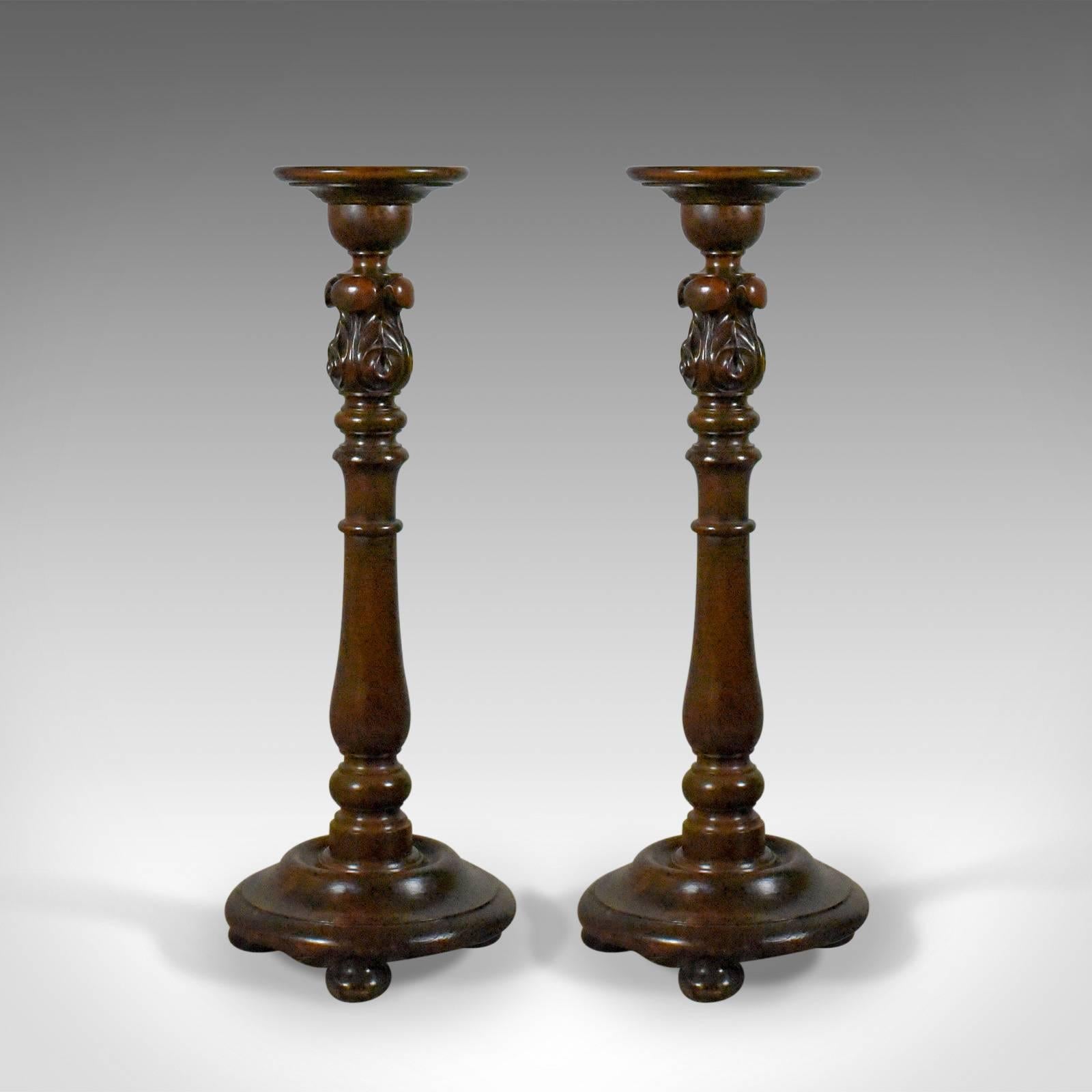 This is a pair of antique torcheres, English, Victorian plant stands in elm and mahogany dating to circa 1900.

Displaying deep russet tones to the quality mahogany stems
Anchored on turned elm plates with grain interest
Raised upon quality bun