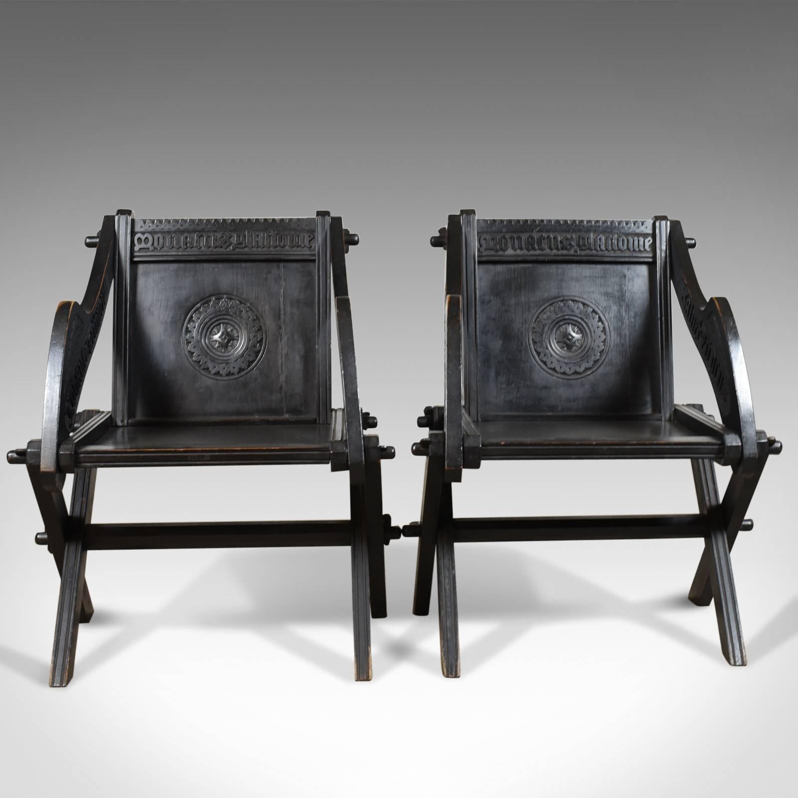 This is a pair of antique Glastonbury chairs, English Tudor Revival carved hall seats dating to the early 20th century, circa 1900.

A fine pair of Glastonbury chairs faithful to their origins
Exhibiting ecclesiastical and gothic