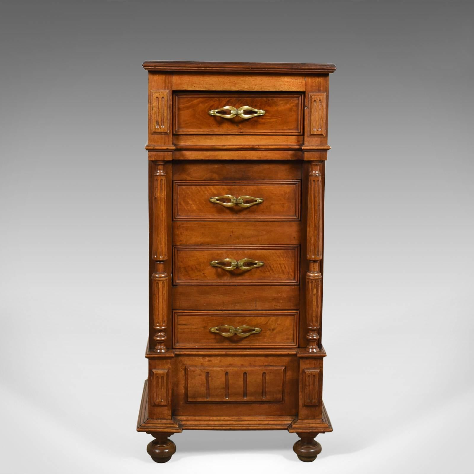 This is a French antique side cabinet, a narrow pot cupboard or nightstand in walnut dating to circa 1900.

Mellow tones and grain interest to the French walnut
Breakfront design with neo-classical overtones
Raised on traditional bun feet to the