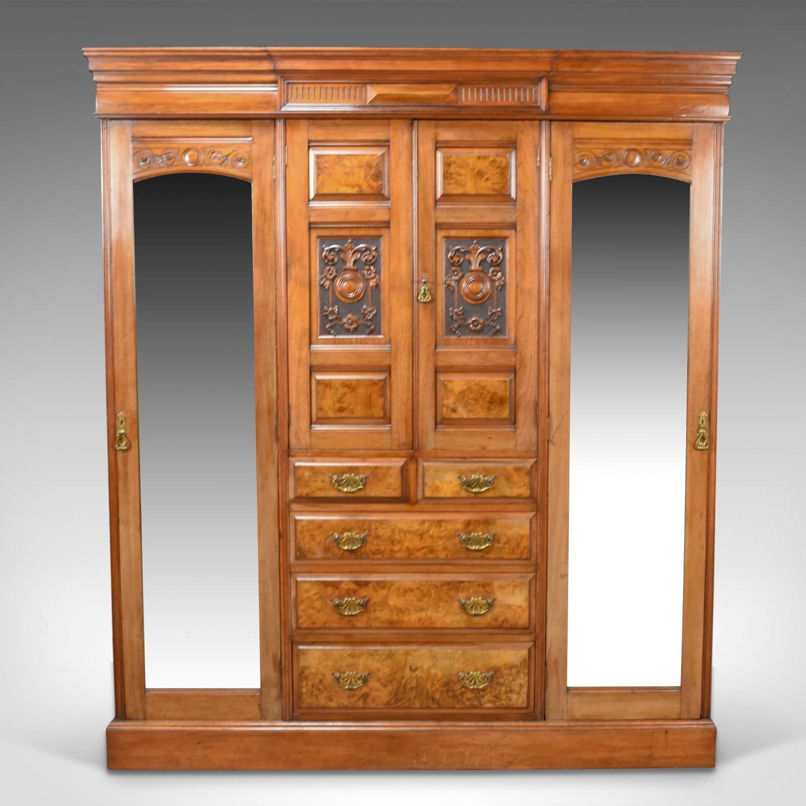 This is an antique wardrobe in English walnut, a compactum dating to the Edwardian period, circa 1910.

Of quality craftsmanship offering generous storage
English walnut with burr walnut drawers fronts and panels
Good color throughout with a
