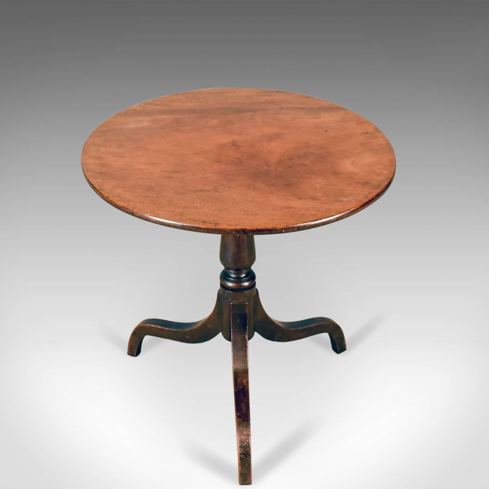 This is an antique side table, a circular, Georgian, mahogany tea table, English, circa 1800.

Appealing patina and grain interest in the mahogany
Good color depth shining through the wax polished finish
Modest proportions ideal as a lamp or