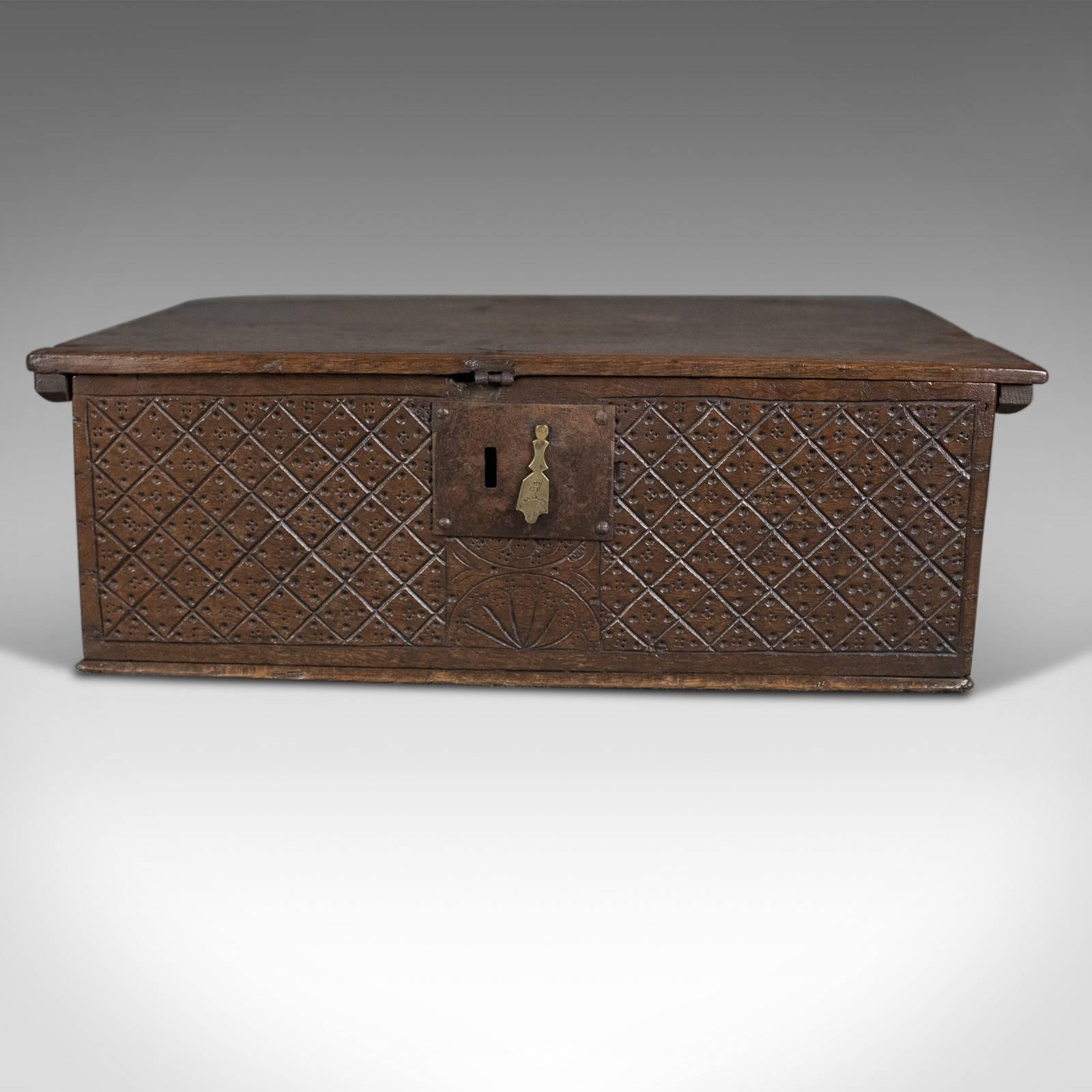 This is an antique bible box in English oak, a chest dating to circa 1700.

Charming country piece with huge character
Dark oak displaying medullary rays inside the lid
Desirable aged patina

Front displays diamond geometric carved