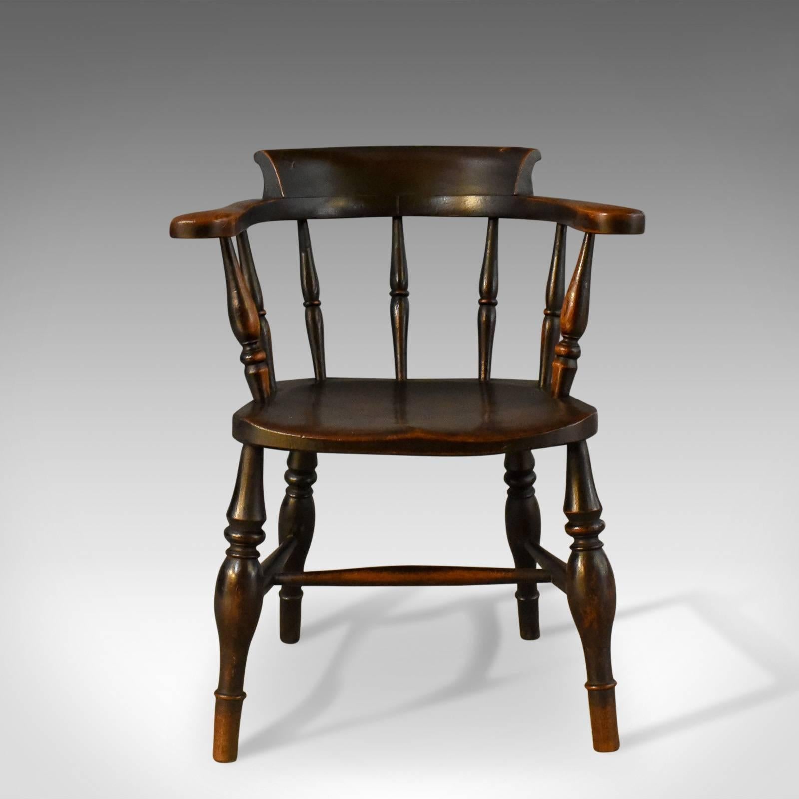 This is an antique, bow-back chair, sometimes referred to as a 'Smokers' or 'Captain's' chair. An English, Victorian elm Windsor piece from the mid 19th century c.1870. 

Attractive deep, rich tones to the elm with a desirable aged