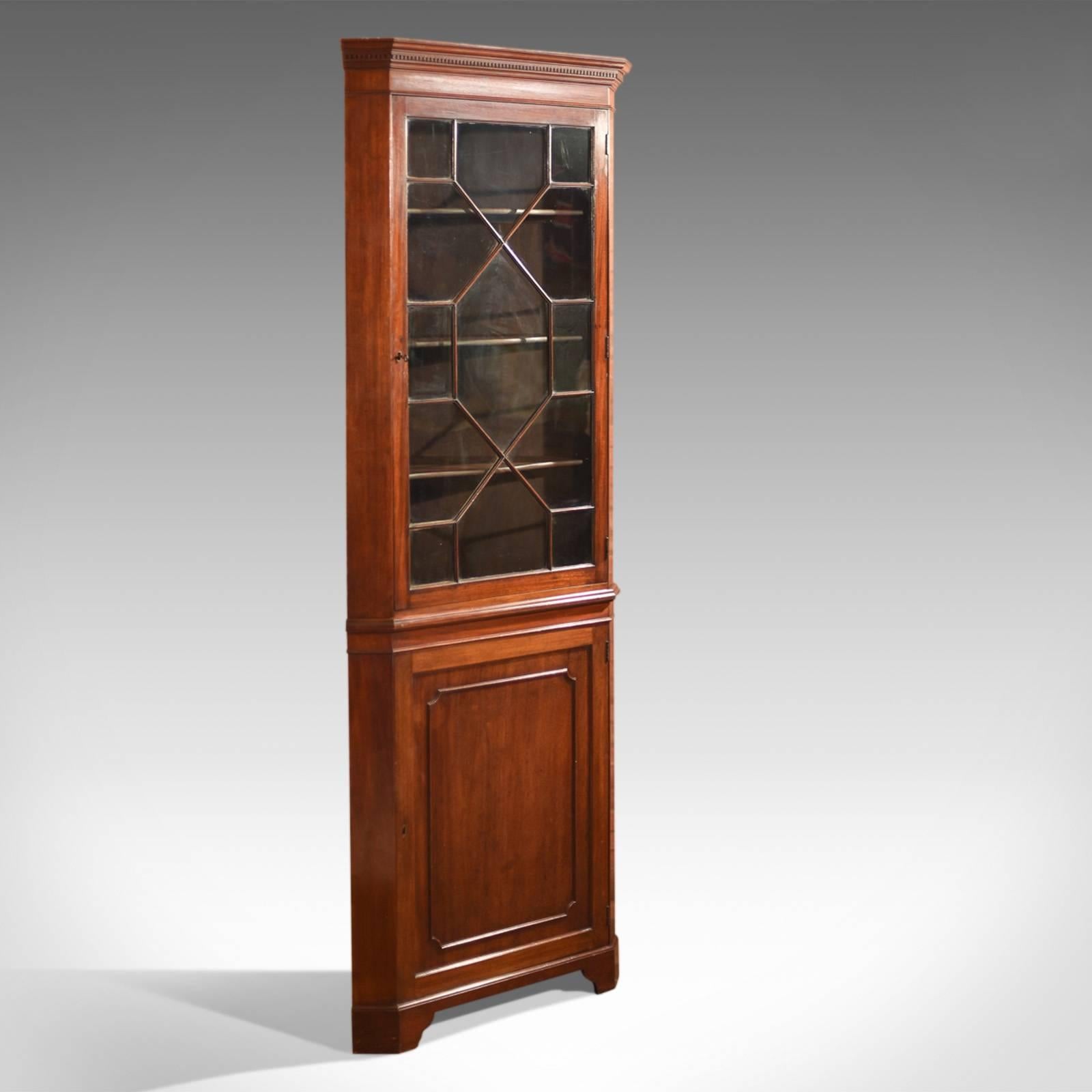 This is an antique, Edwardian glazed corner cabinet dating, circa 1910.

Beautifully made in a Georgian revival style, this example is taller than most at 223cm (87.75