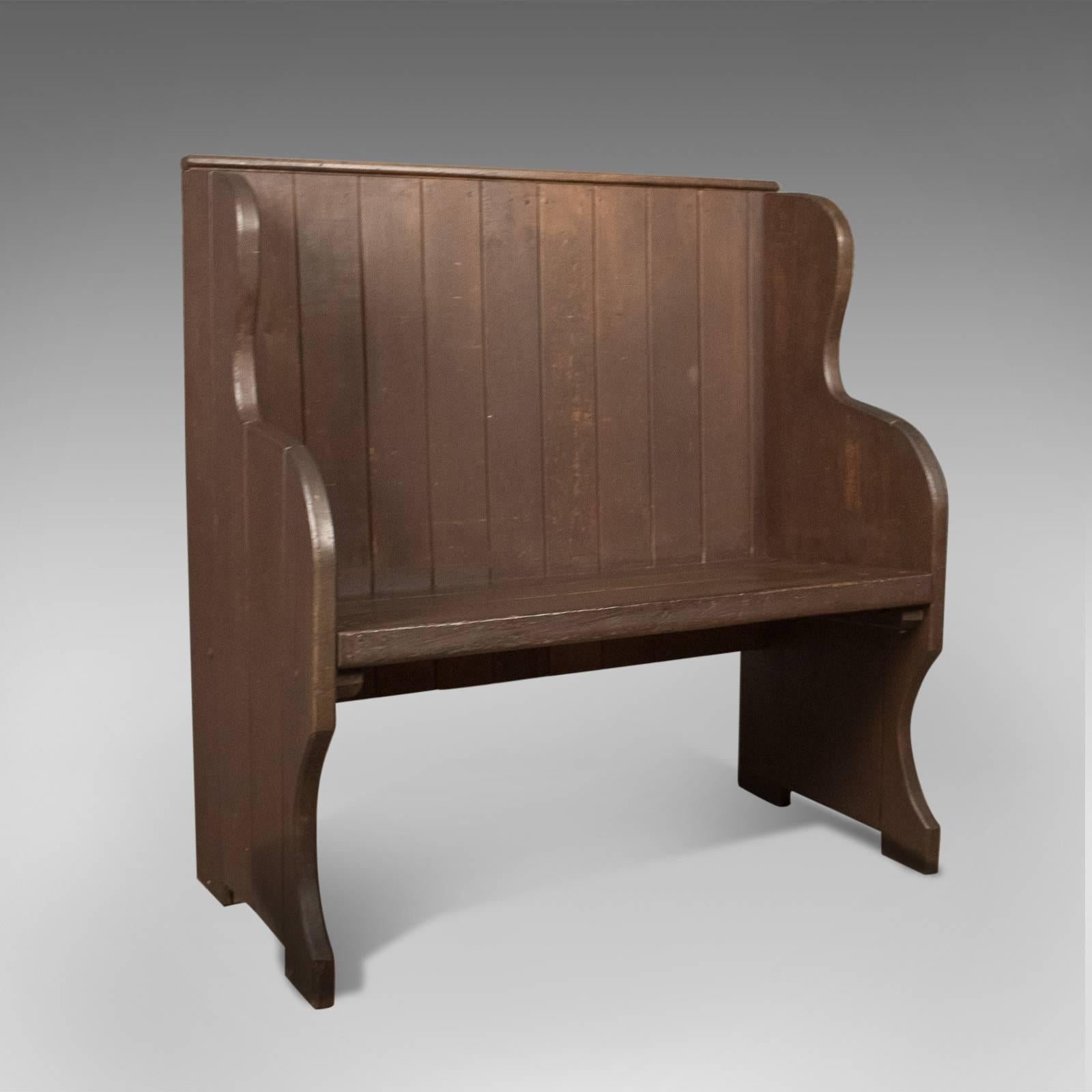 This is an antique settle, a 19th century bench or pew, English, circa 1890.

Solid teak plank construction with a waxed finish
Tongue and groove boards with deep winged sides to prevent draughts
Stained pine back boards with capping.

Shaped