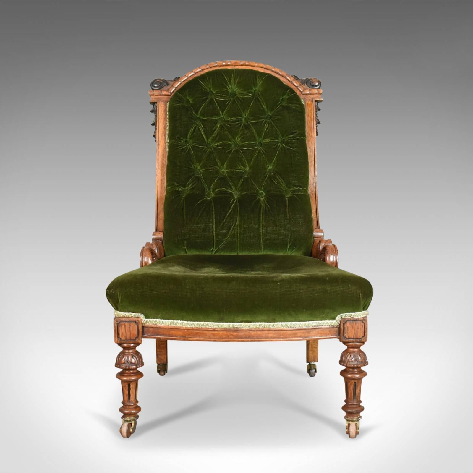 This is an antique chair, an Scottish oak button back nursing, or salon, chair dating to the early Victorian era, circa 1850.

Attractive contrast between the dark, emerald green cloth and oak frame
Desirable aged patina to the oak frame