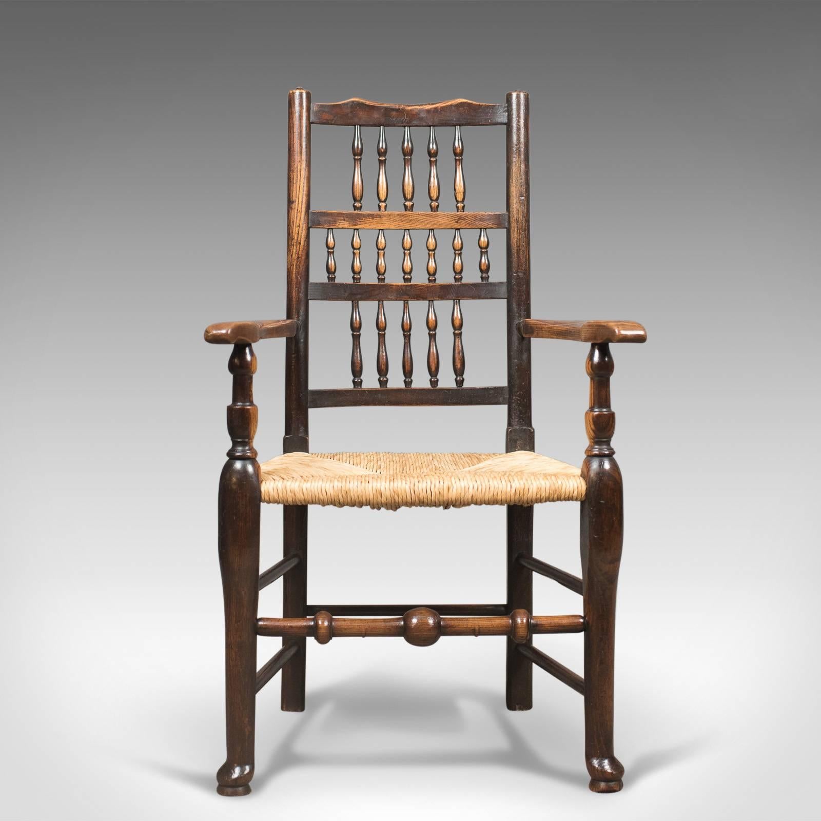 This is a top quality antique elbow chair, a Victorian Lancashire spindle back dining chair.

Appealing rustic farmhouse style in first class order
Crafted in solid English oak with rich warm hues
Particular grain interest to the arms
Solid,