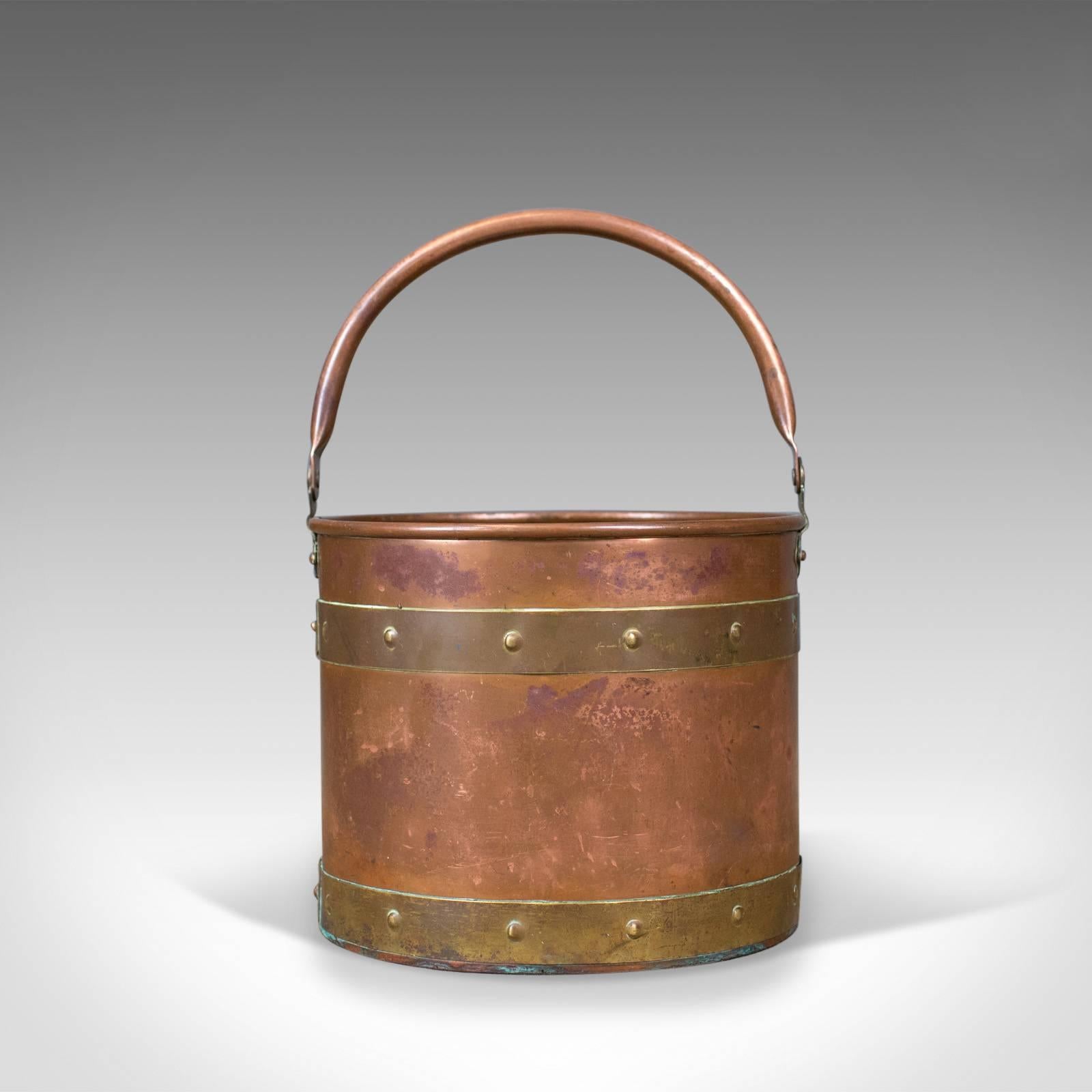 This is an antique coal bucket, an English, Victorian copper and brass fireside log bin or scuttle dating to circa 1890.

An attractive fireside storage bin presented in good antique condition
Suitable for coal, logs and kindling or helpful when