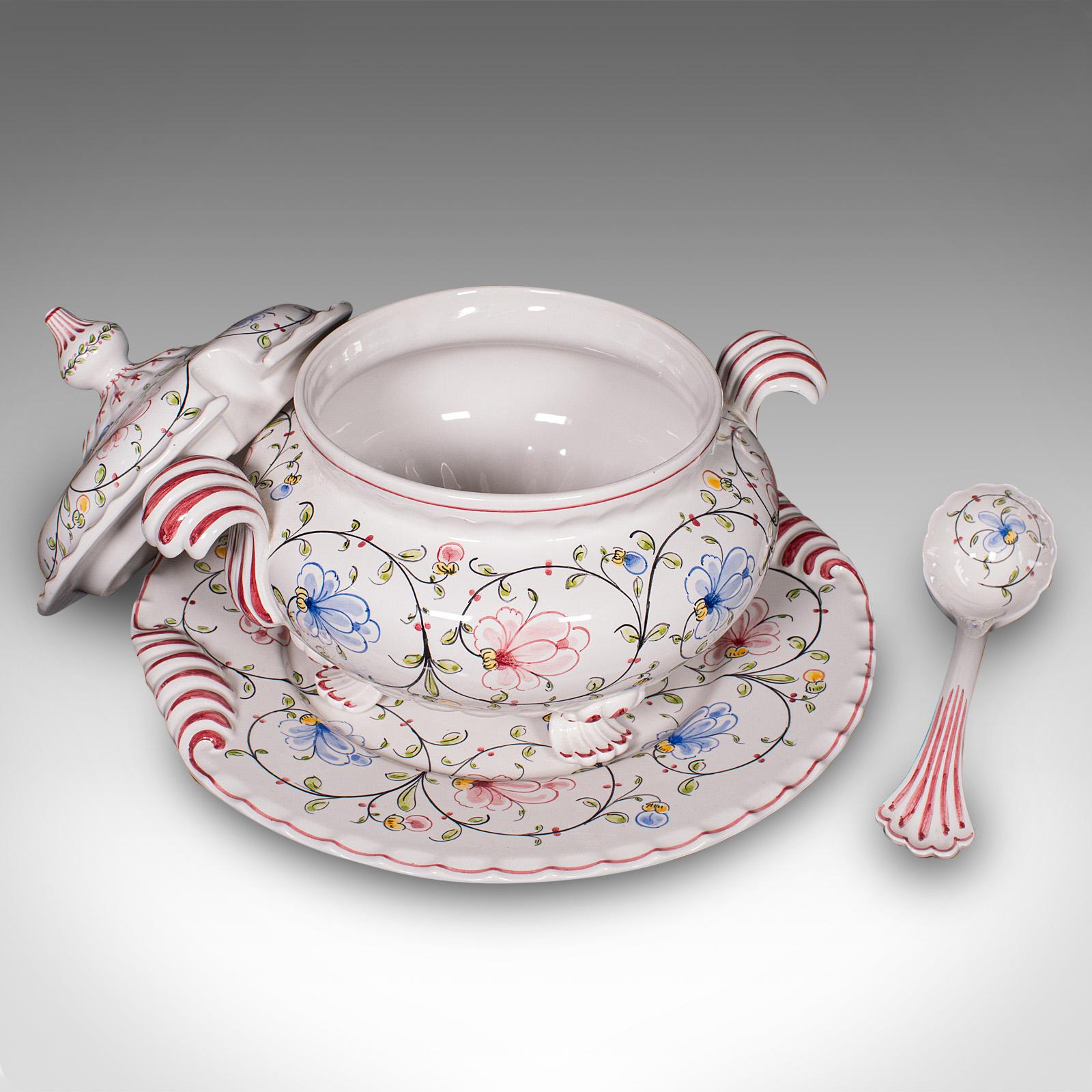 This is a charming vintage soup tureen service. A Portuguese, ceramic serving dish set with platter and ladle, dating to the late 20th century, circa 1970. Displaying delightful flowerhead decor and vibrant detailing, this set makes for an