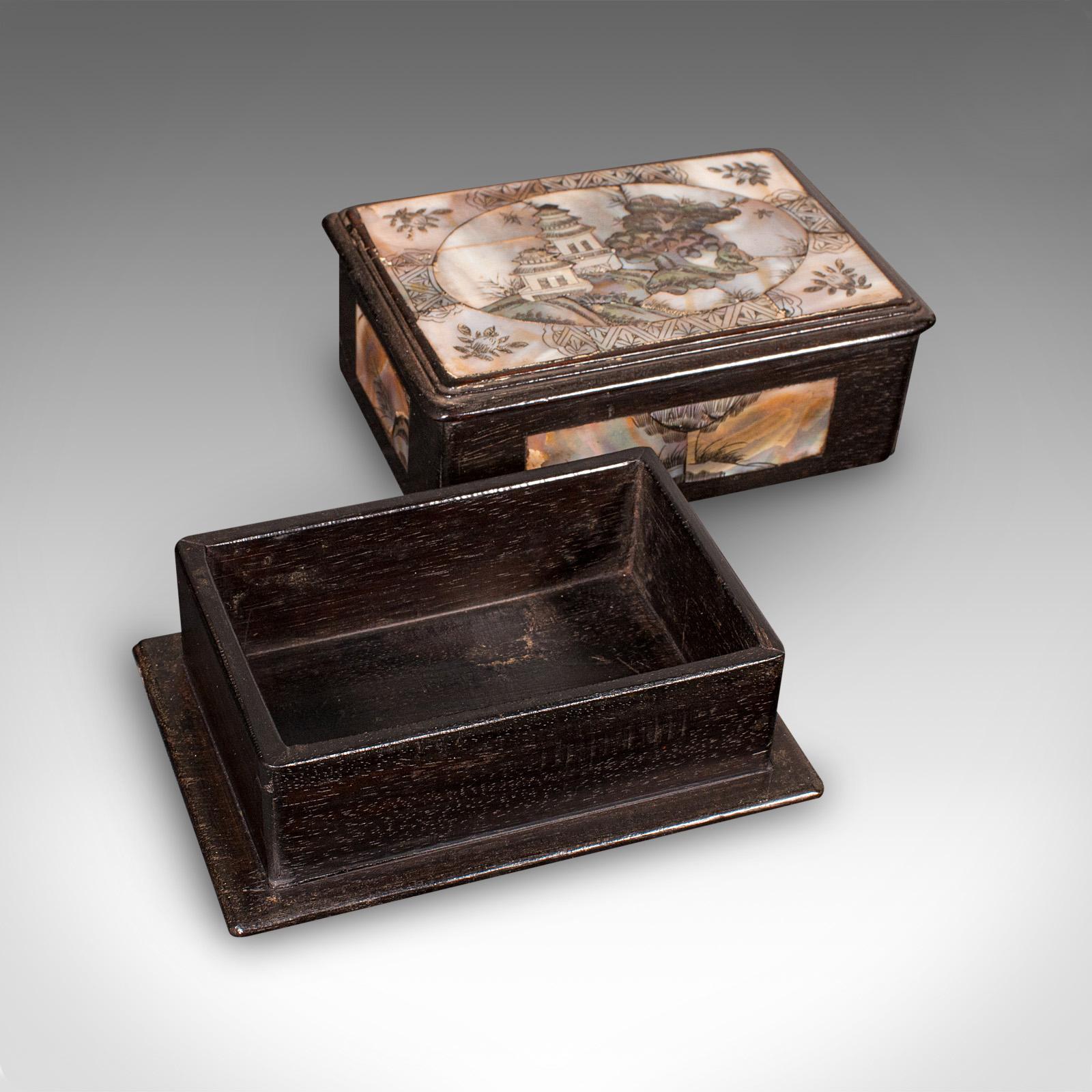 This is a small antique keepsake box. An Oriental, mahogany and exotic stone inlaid decorative Qing dynasty case, dating to the Edwardian period, circa 1910. Eye-catching Oriental elegance with an intricate inlay and rich tones, perfect for the