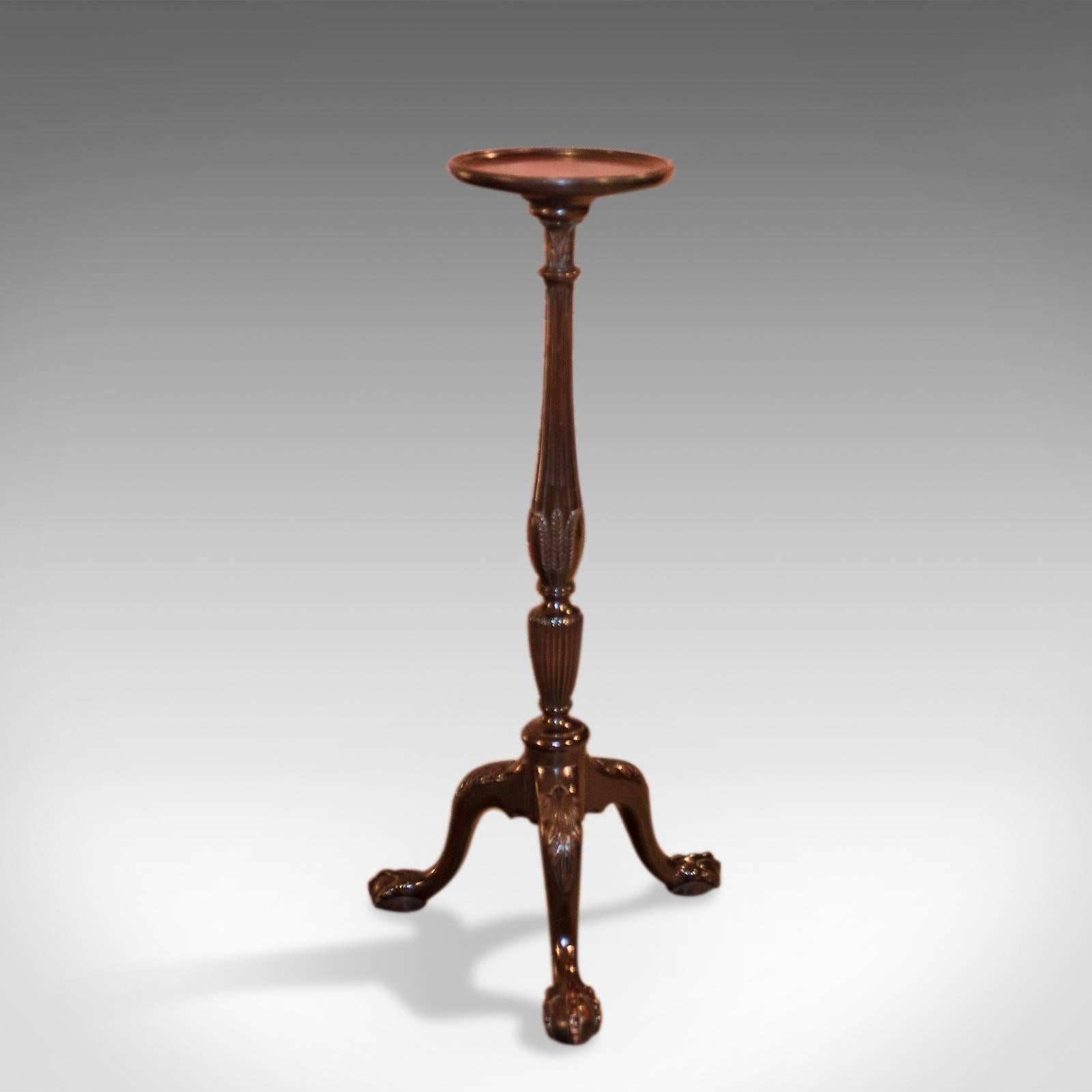 This is an appealing antique plant stand, a Victorian torchere dating to the late 19th century.

Quality dark mahogany with a polished finish
Raised on talon and egg feet
A tripod of cabriole legs with carved acanthus leaf knees
Turned stem