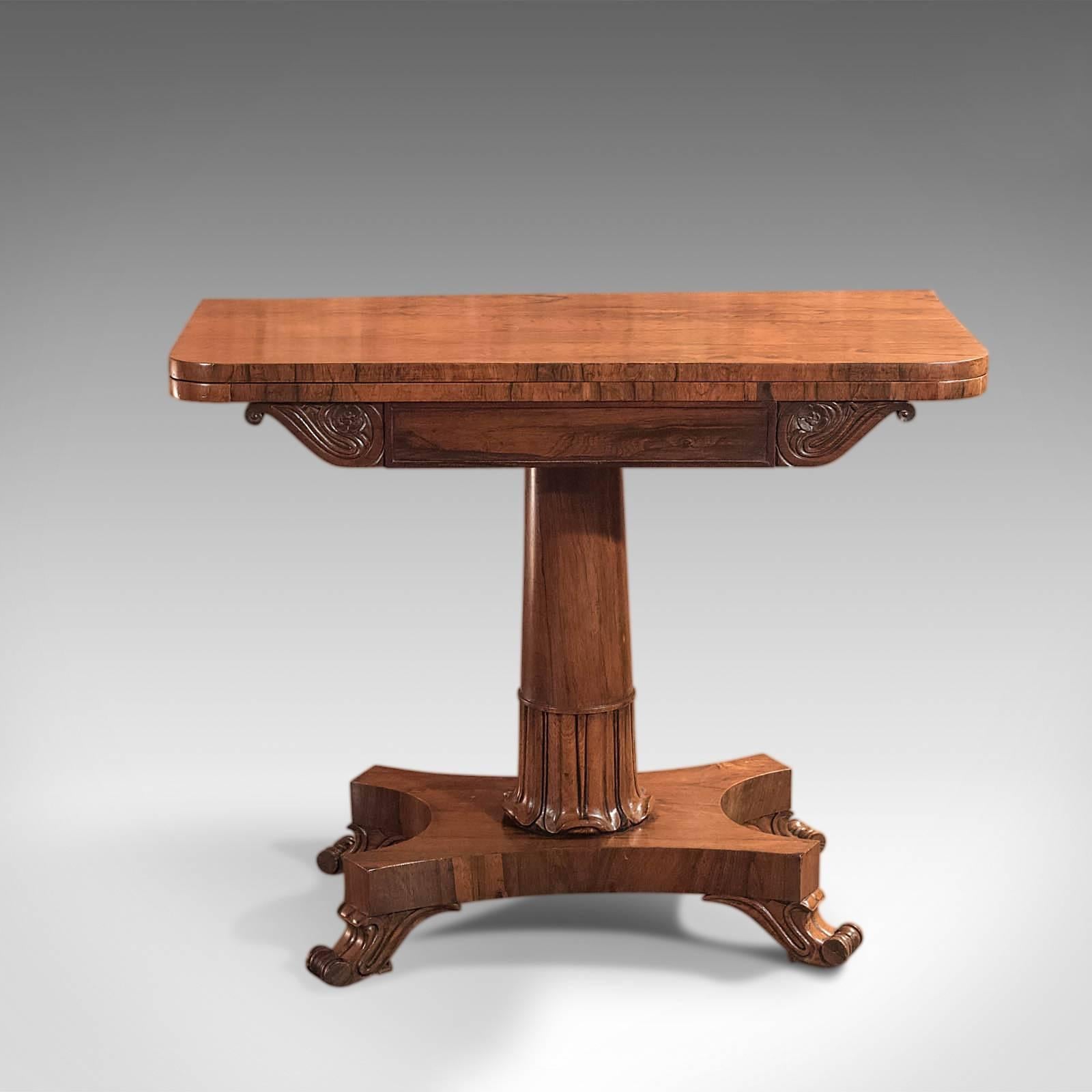 This is an antique, fold-over card table dating to the mid-Victorian period, circa 1850.

This table displays the most wonderful rosewood grain detail and a desirable aged patina in a piece of good proportion. Closed, it makes for an attractive