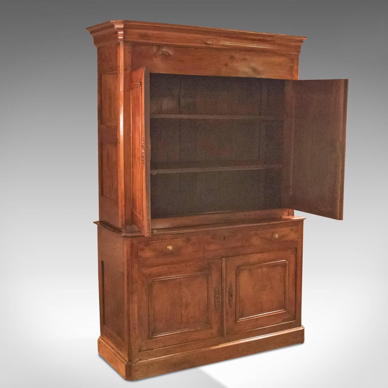 This is an antique buffet a deux corps, French dating to the late 18th century, circa 1780.

Crafted in stout fruitwood stock finished with yew wood
Desirable color with good grain interest and a beautifully aged patina
Country kitchen appeal in