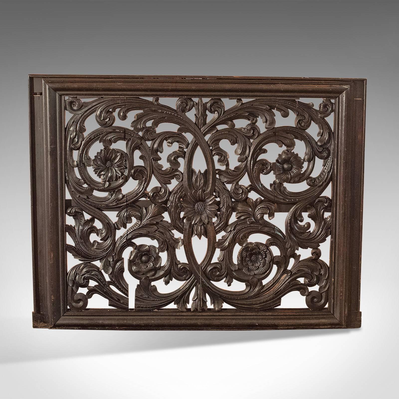 This is a magnificent, decorative, antique wall panel dating to the Victorian era.

Floral rosettes mounted in sinuous foliate scrolls
A pierced carving in English oak
Mounted in moulded frame
Desirable color and aged patina
Well executed deep