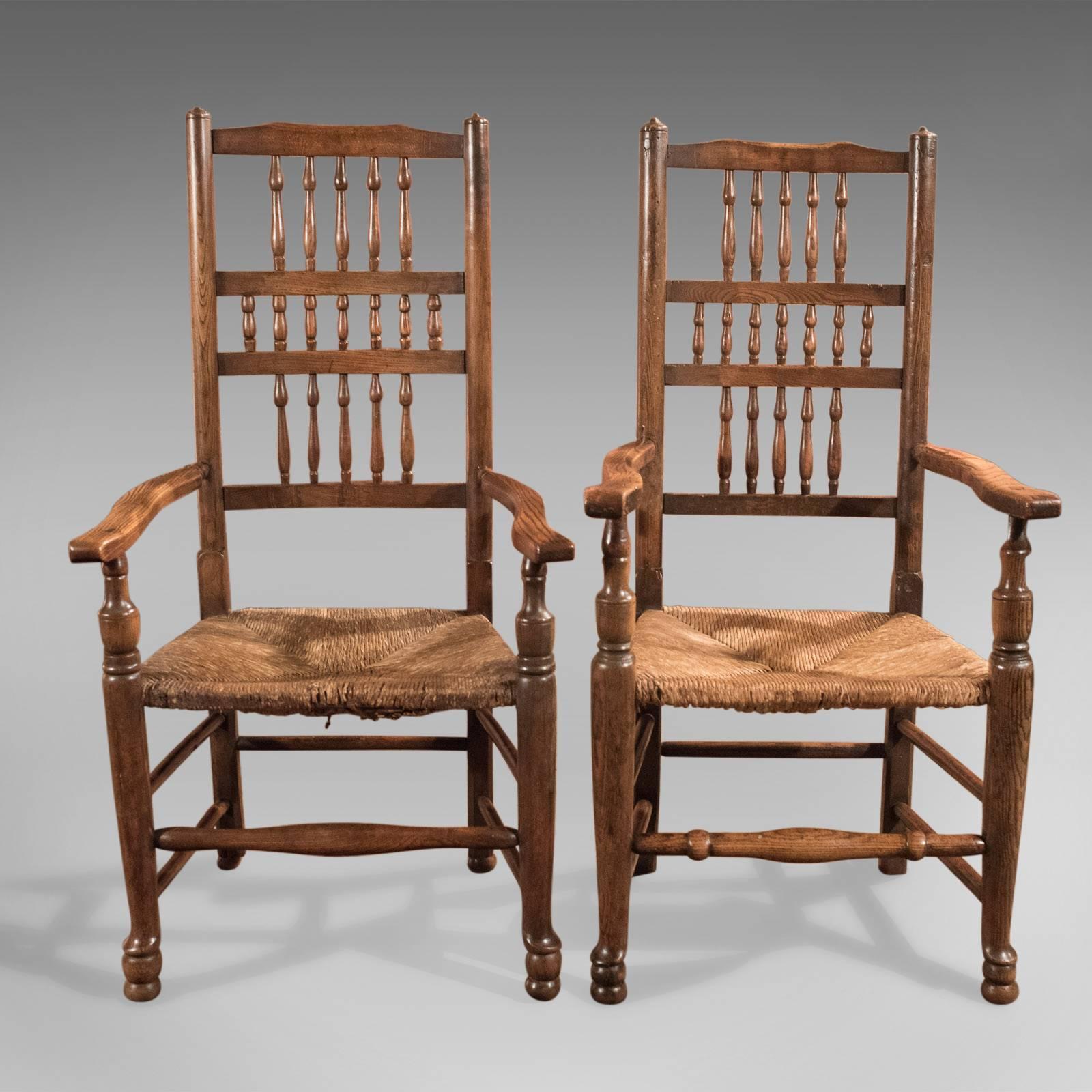 A harlequin set of Georgian, spindle back, rush seated, dining chairs comprising five singles (three and two) and two carvers dating to circa 1800.

Crafted in traditional oak, ash and elm
Wonderfully rich patinated original wax finish and