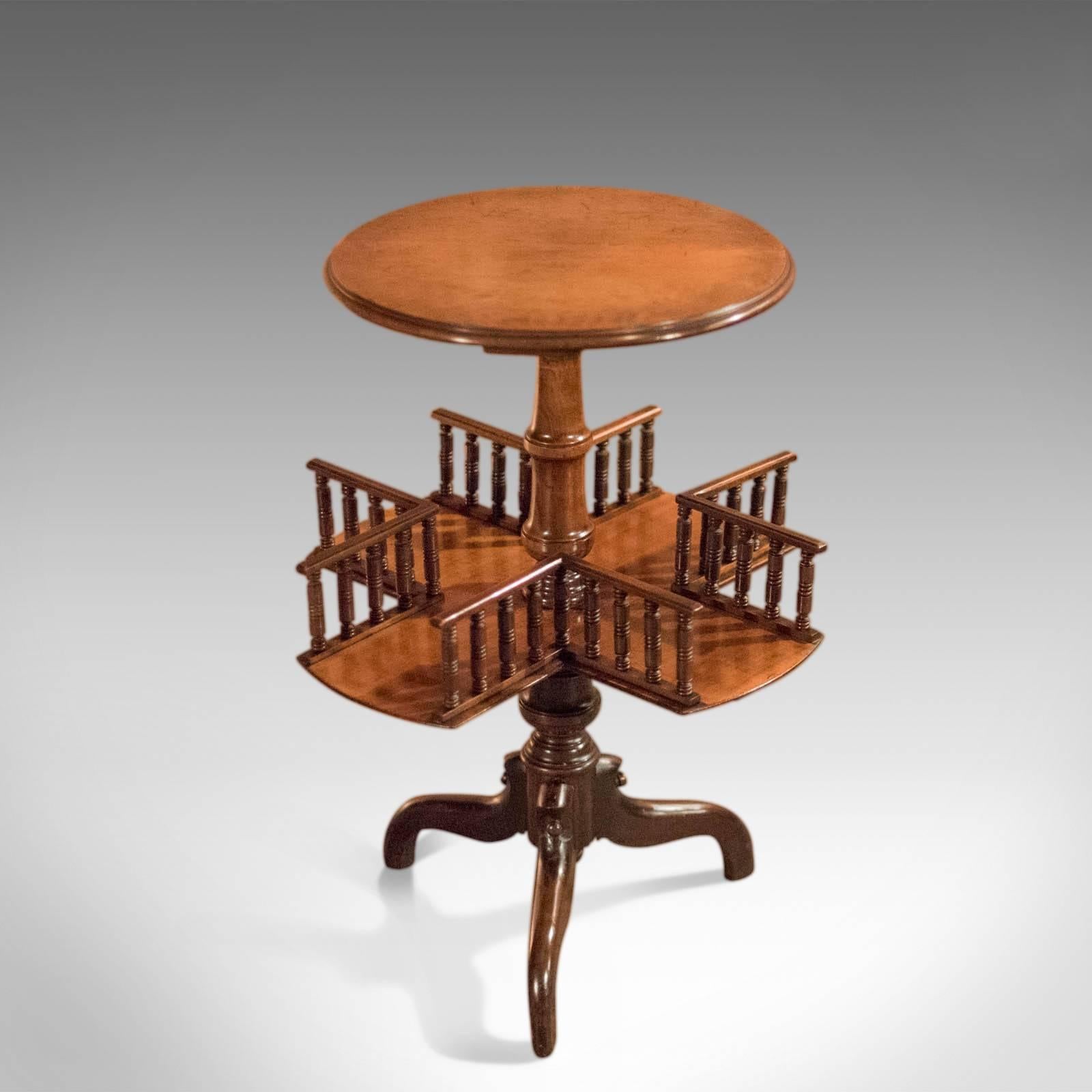 This is an antique, Victorian wine table with revolving bookshelf dating to circa 1850.

On a tripod of down-swept legs the table is raised on a stout, ring turned column. The legs with pegged detail and a hanging, central flat finial.

The