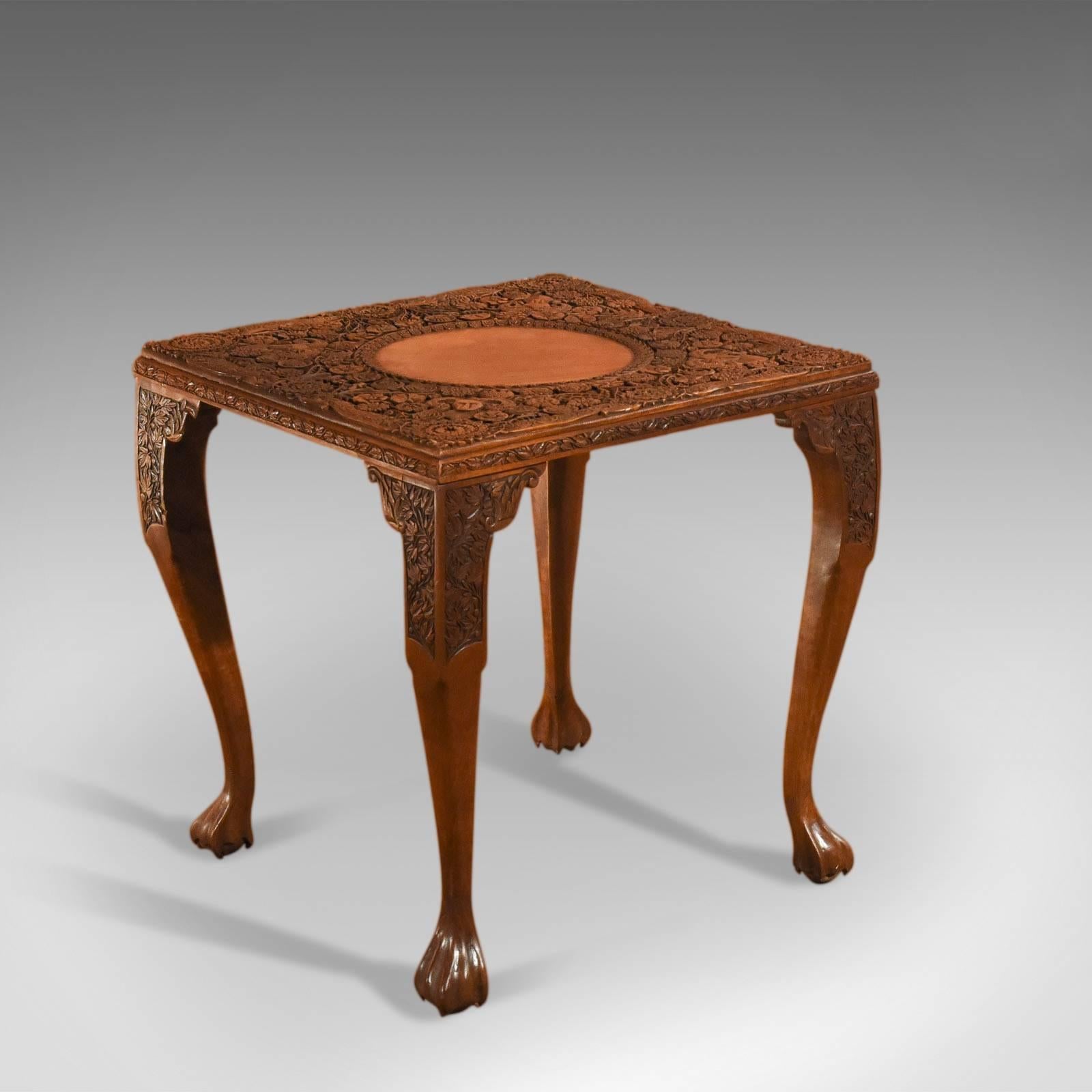 This is an antique, Victorian tea table dating to circa 1900.

Based around symmetrical anchors of radial decoration at the corners and mid points, bearded goats heads and the inner ring of flower heads, the profusely carved rosettes vary in
