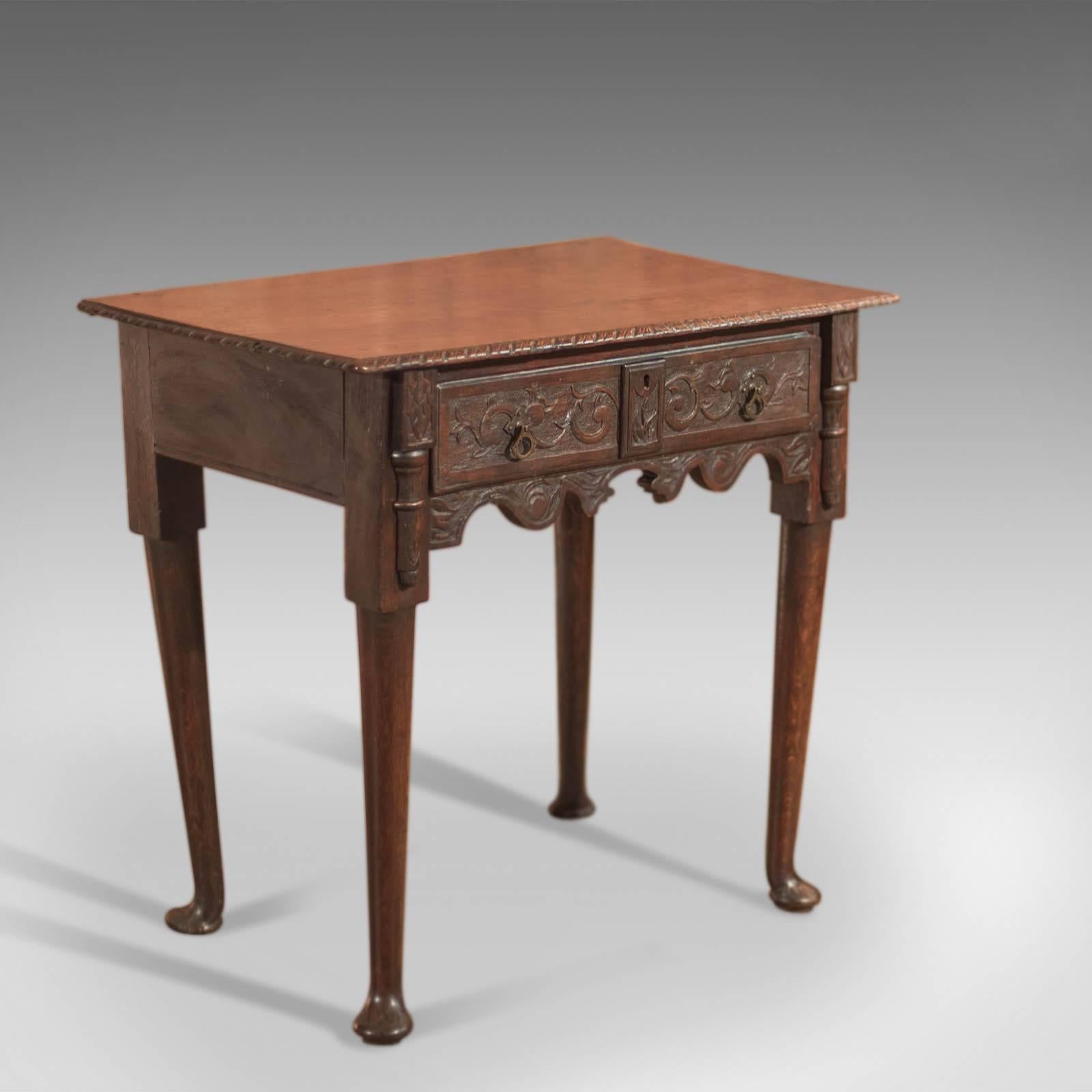 This is an antique, 18th century, Provincial side table, circa 1750.

Raised on slender, tapering, turned legs terminating in out-turned pad feet, the front feet are decorated with relief foliate carving.

The serpentine apron is heavily carved