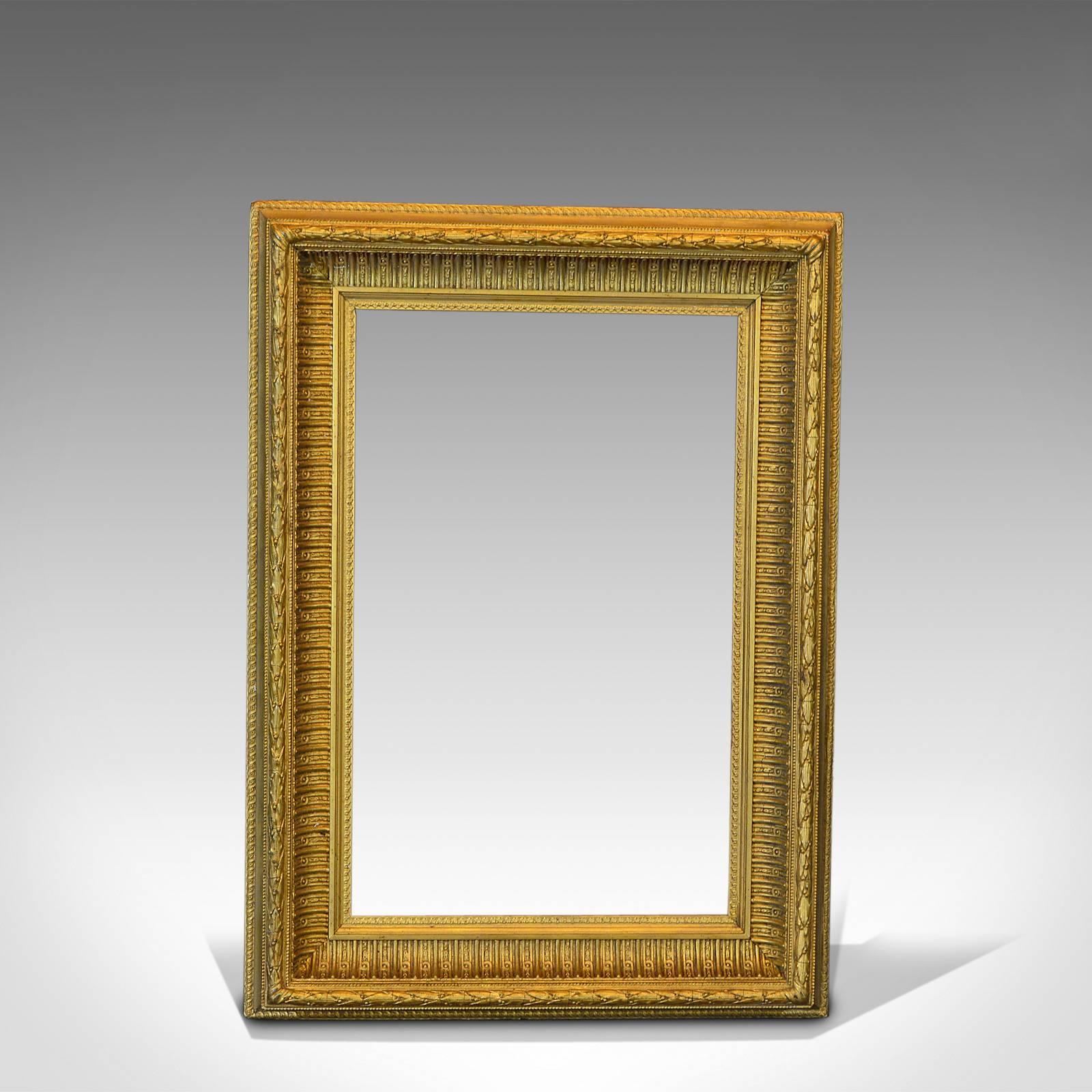This is an antique gilt gesso picture frame dating to the Victorian period, circa 1880.

A mid-sized frame with complete, original mouldings, the wood and gilt gesso displays an attractive aged lustre. Suitable for landscape or portrait hanging