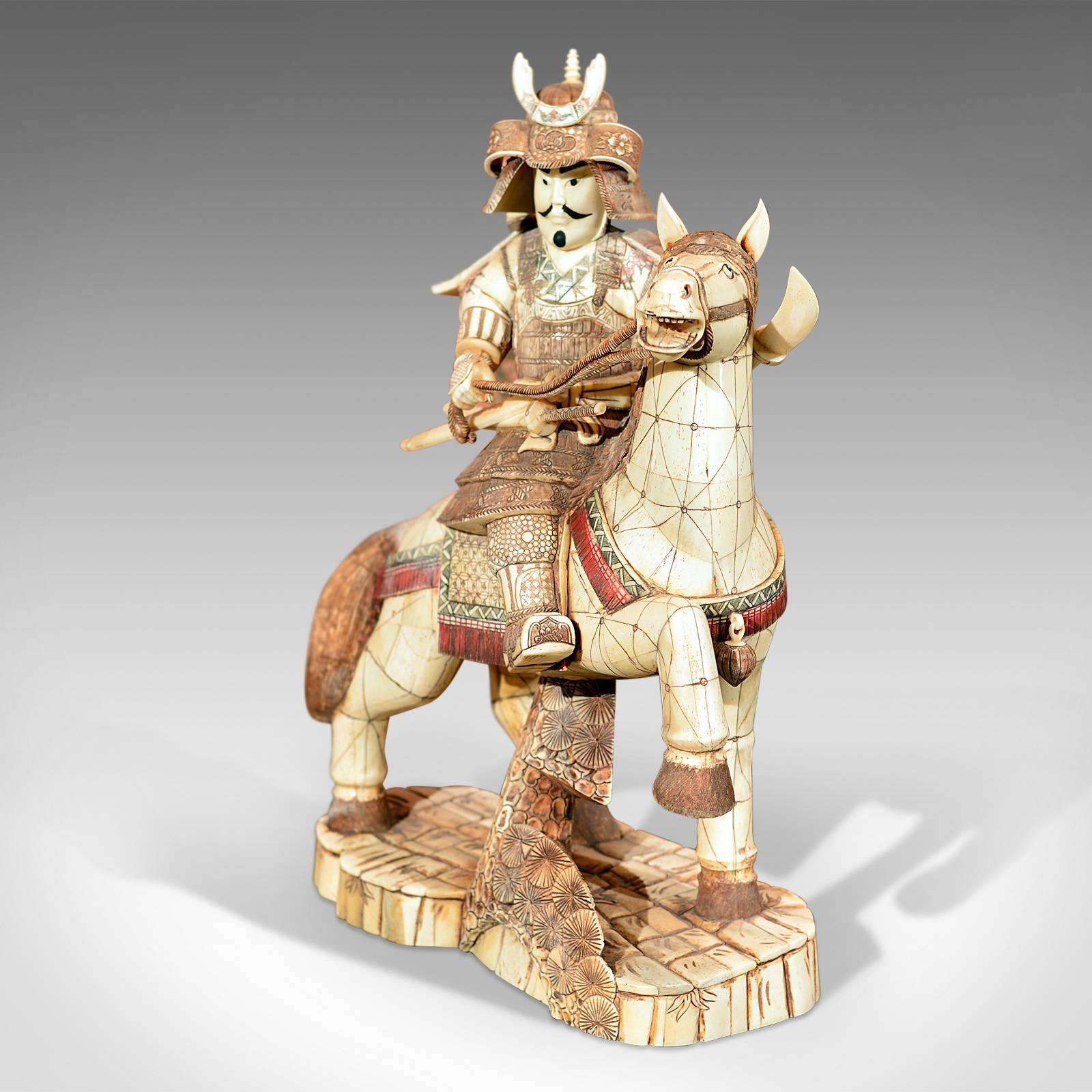This is a Japanese okimono, oriental art carving dating from the early 20th century.

A rare bone piece in excellent condition and a real statement piece of some size at 33cm (13