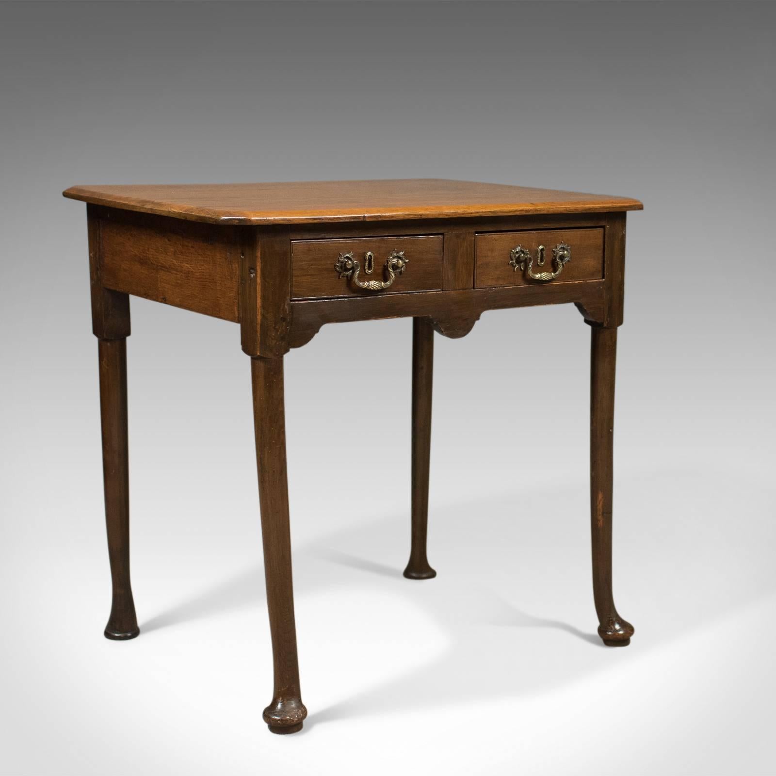 This is a charming, country, antique lowboy dating to the Victorian period, circa 1850.

In English oak with a waxed finish and desirable aged patina
Three plank top displaying good grain interest and wisps of medullary rays
Canted corners and a