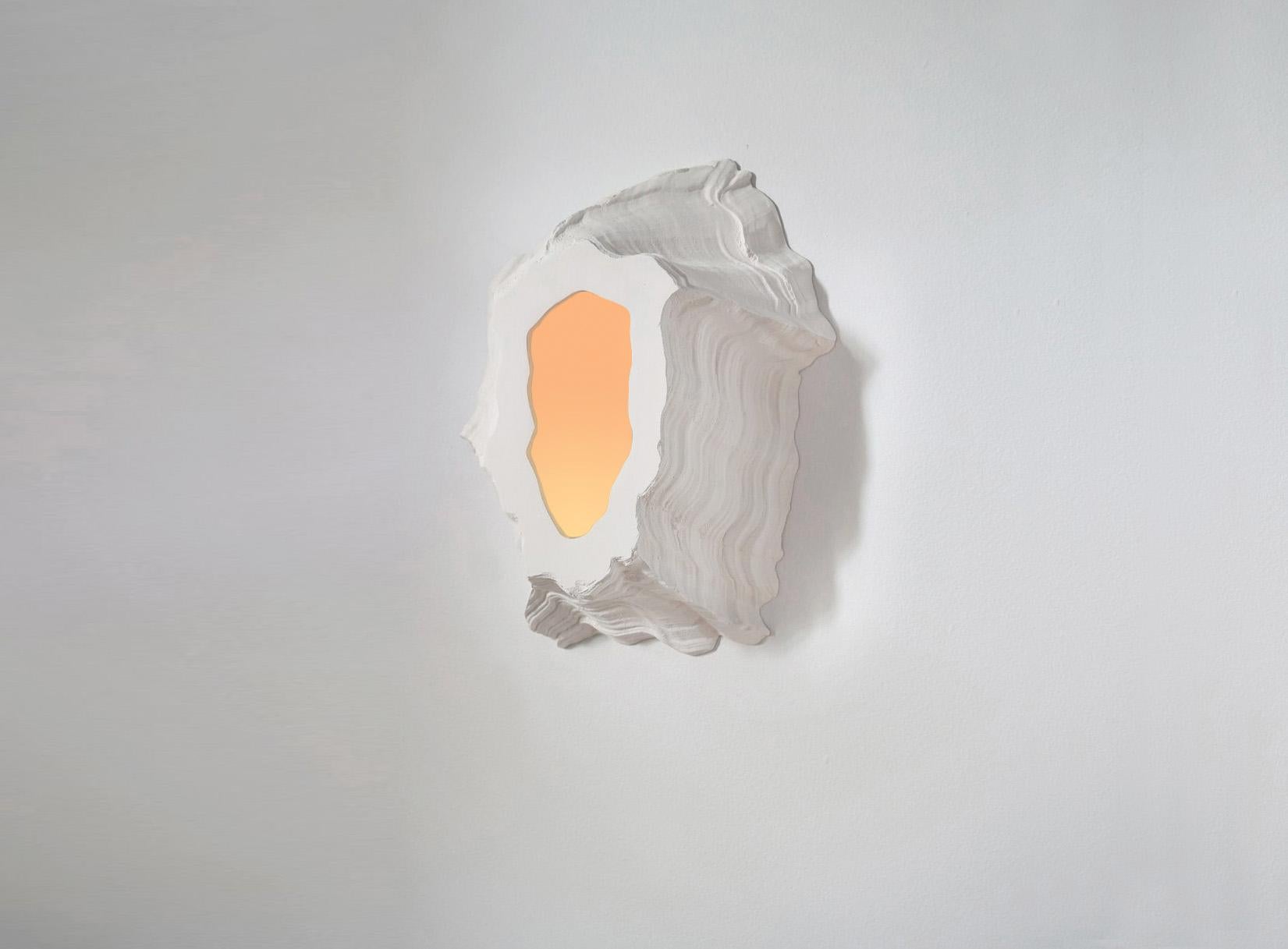 The Portals are a collection of wall mounted ceramic pieces, either illuminated or reflective. The irregular and highly textured objects evoke bleached coral, lava scars or even barnacles. The collection includes the four first versions of an