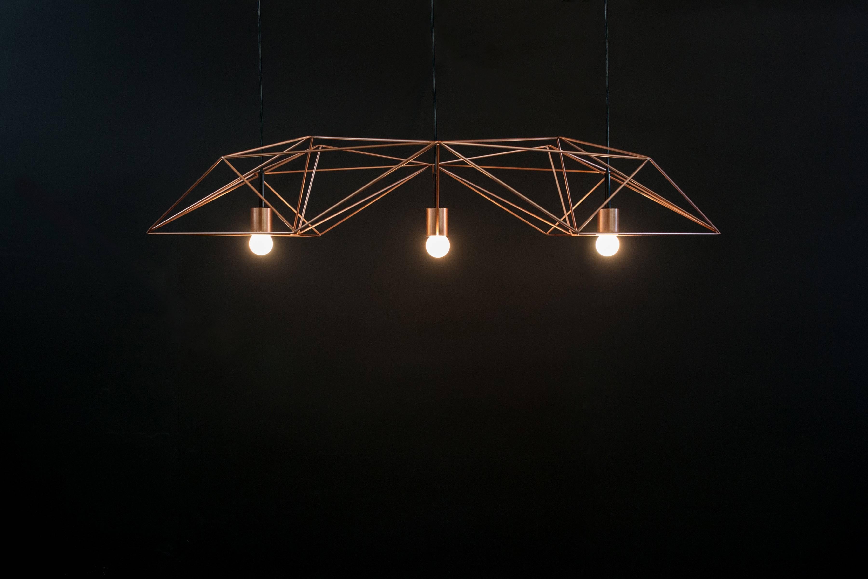 The ‘Crystalline Light’ is a statement chandelier, light in form yet strong in presence. Inspired from mineralogy, this piece – crafted from thin steel rods – gives form and movement to complex patterns depending on your viewpoint. It’s geometric