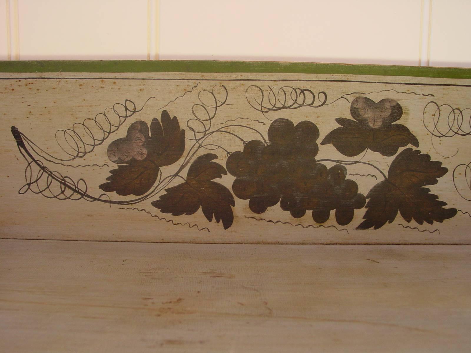 Of elegant proportions, this serving table retains its original gray and green painted finish with a grape and vine stencil motif decorating the backsplash. Of New England origin, probably made in Worchester, Massachusetts. For a closely related