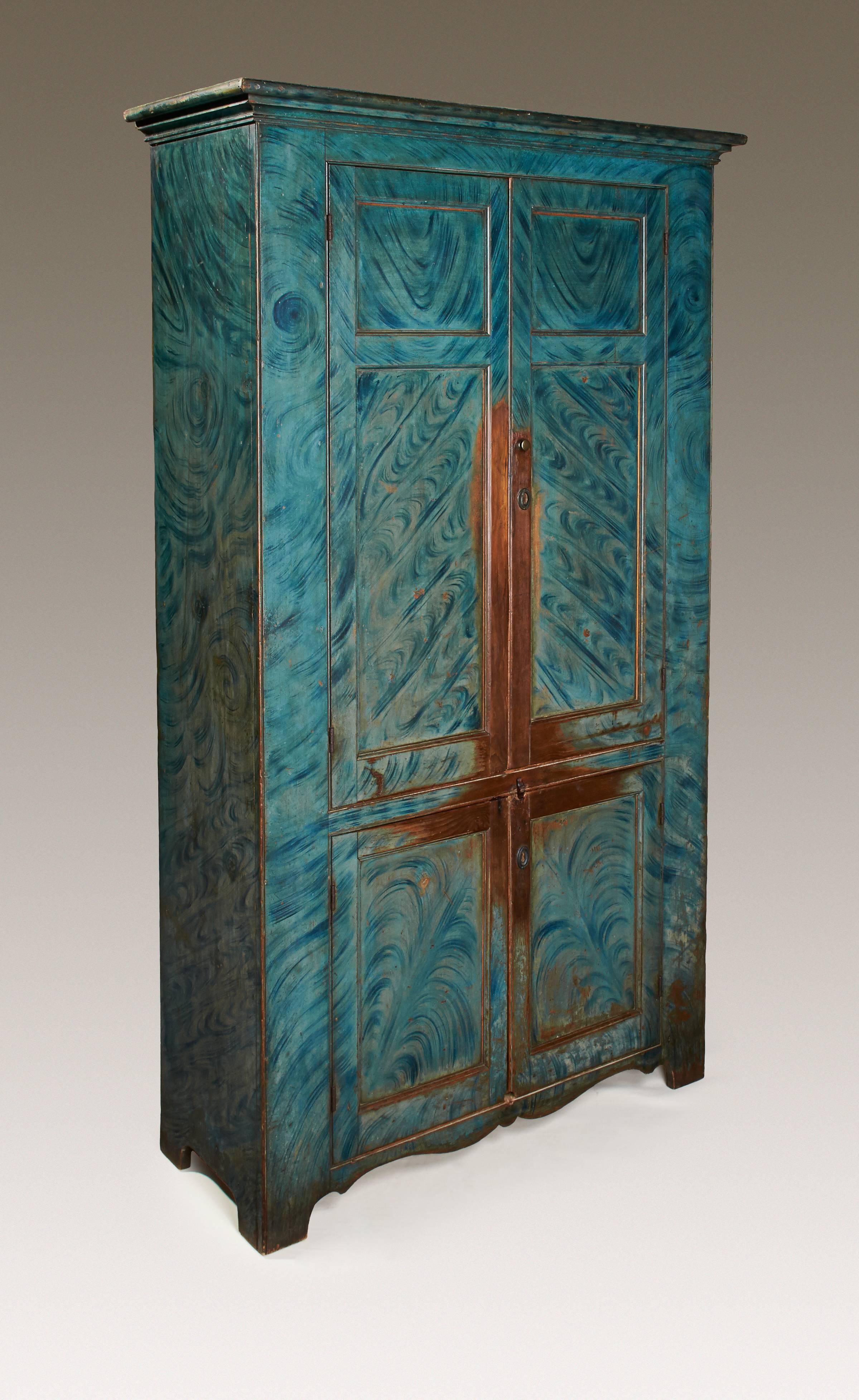 A four-door cupboard with original red-painted interior, shelves with carved plate grooves and the original, striking blue paint-decorated finish. A rare example from Hunterdon County, New Jersey in the Delaware Valley and an exceptional piece of