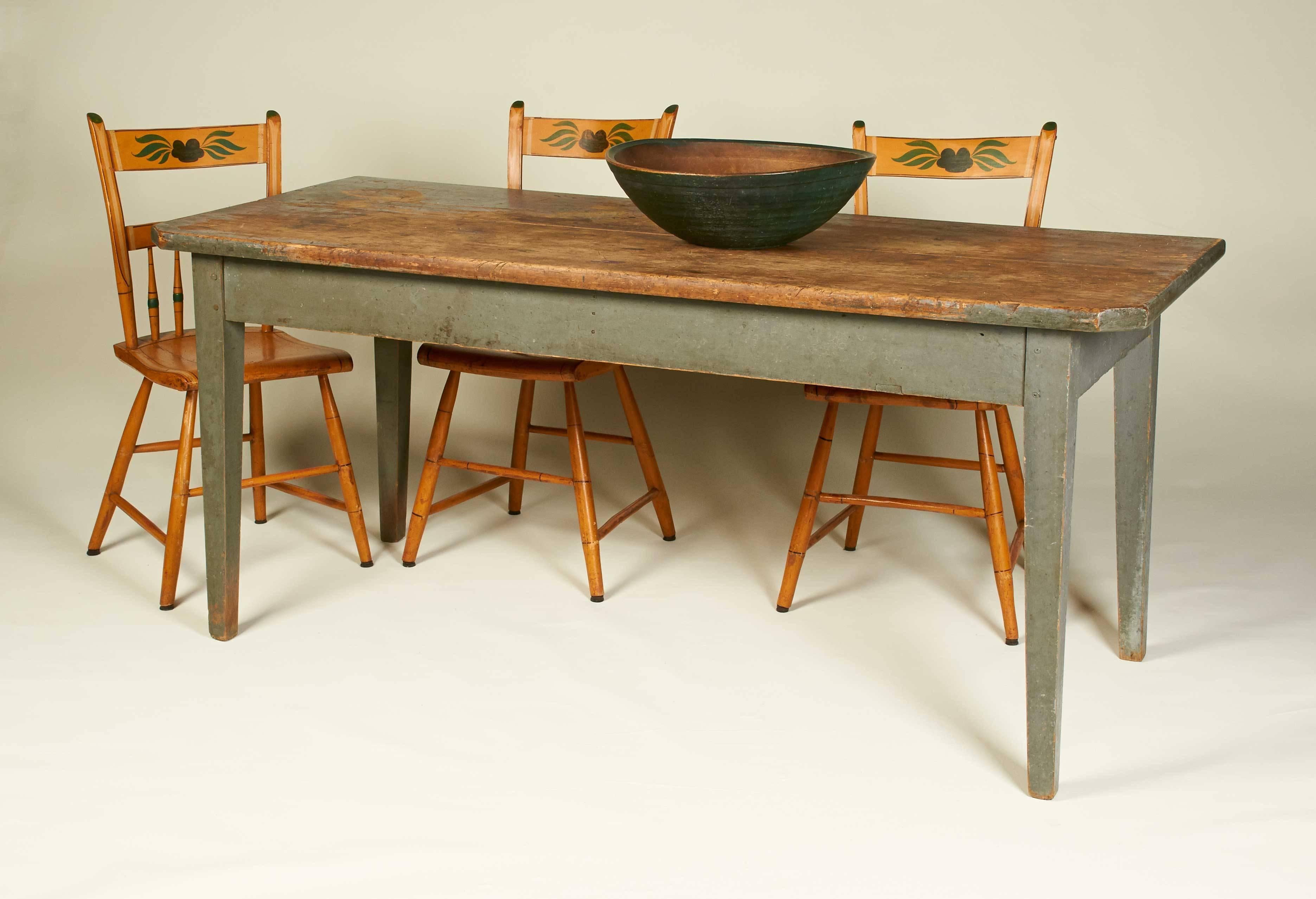 A Pennsylvania farm table with two-board scrubbed top above square tapered legs retaining a wonderful blue-grey painted finish. Perfect as a country dining or breakfast table. Can seat six.