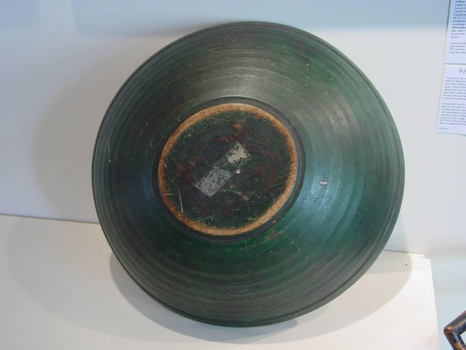 A country turned elm treenware bowl with original rich, deep green painted finish. This Folk Art painted bowl also features pronounced turning and a narrow lip.