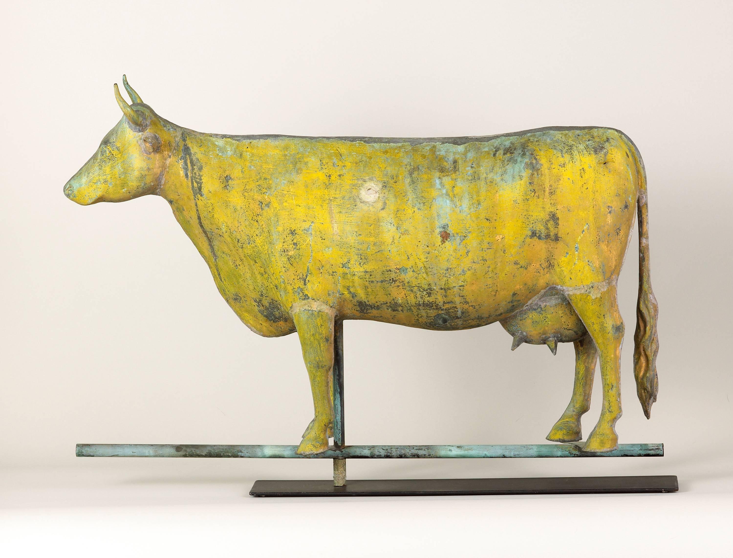An exceptional Folk Art full-bodied cow weathervane of molded copper and cast zinc. This cow weathervane retains a beautiful weathered surface of yellow sizing, traces of gilt and verdigris. Possibly by Harris and Co. of Boston, Massachusetts.