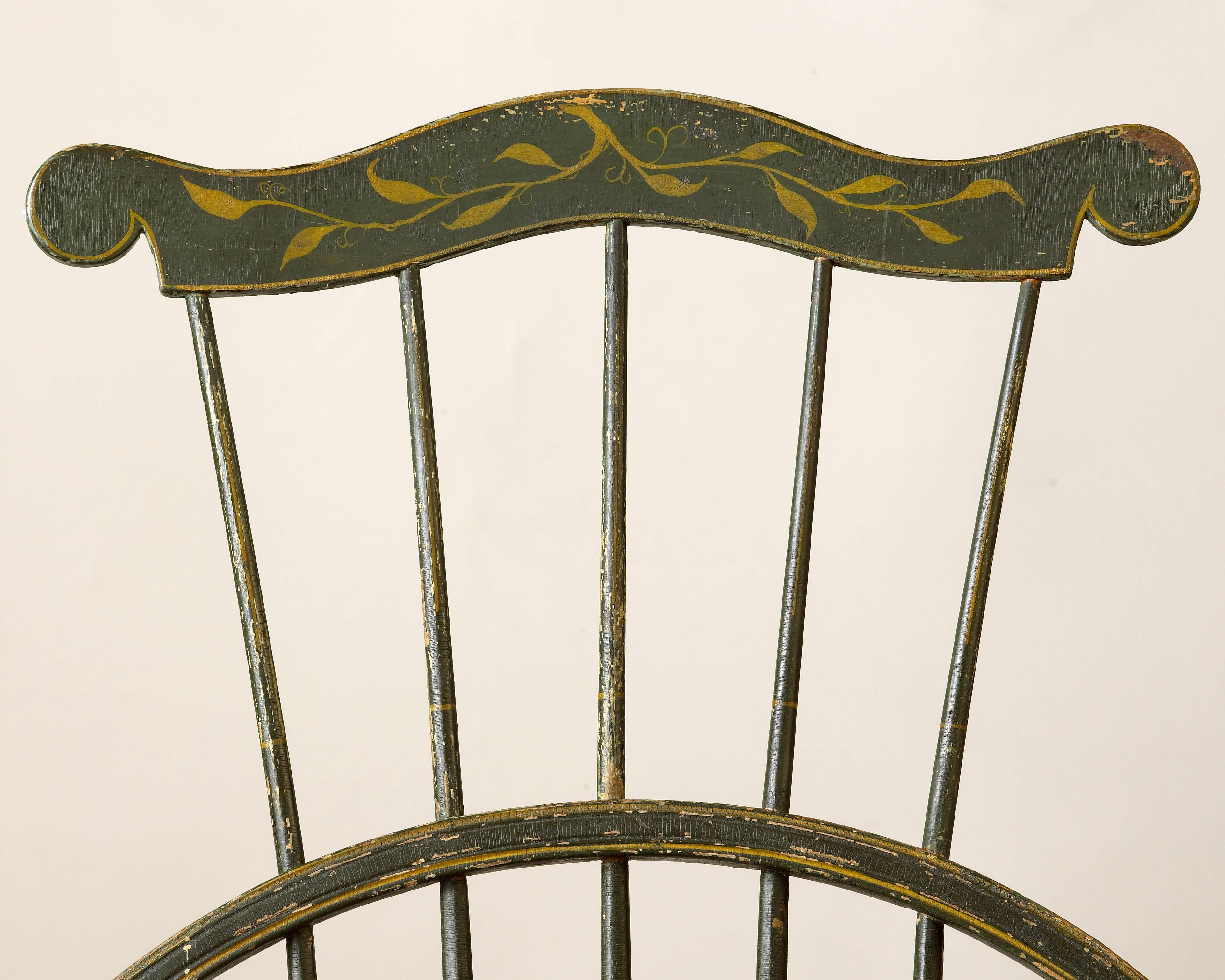 A New England comb-back Windsor side chair featuring an original green-painted finish accented with yellow striping and foliate decoration on the crest. Likely produced in Rhode Island or Massachusetts, this Windsor side chair is further enhanced by