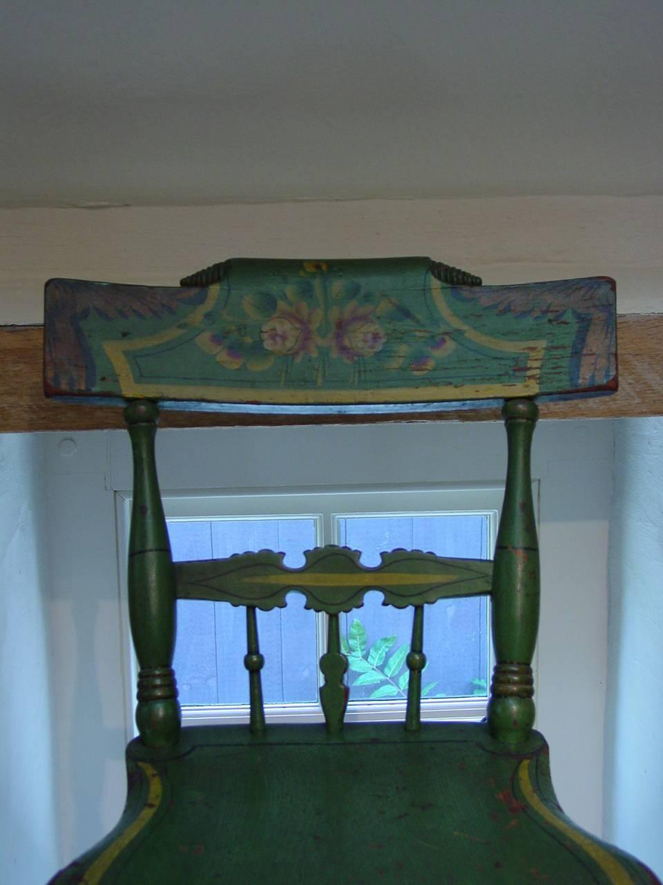 A charming Pennsylvania carved and turned child's chair with original apple-green ground under floral-stencil and gilt decoration. A highly decorative child's chair of desirable proportions suitable for a variety of uses.