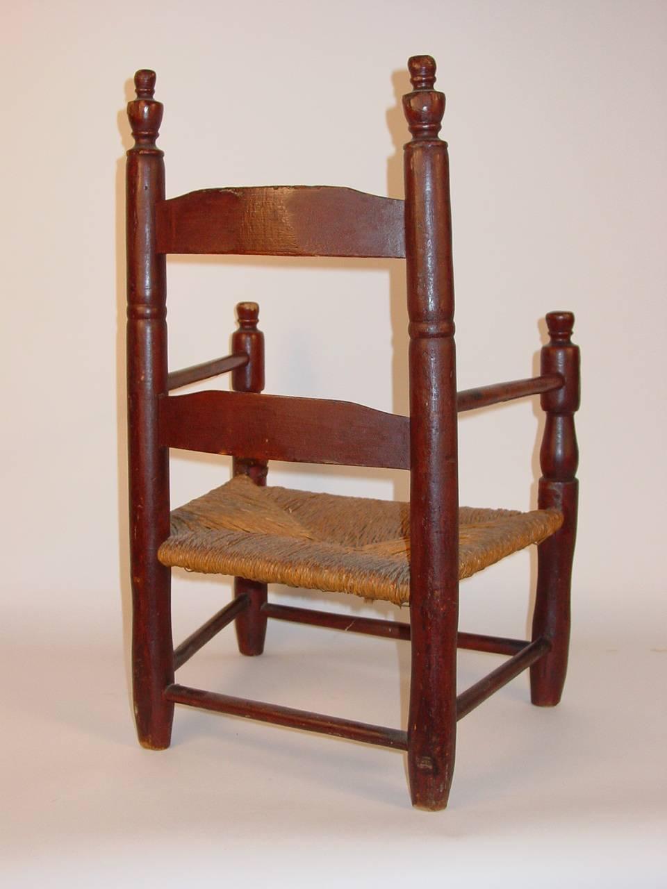 A child's ladder-back armchair
Bergen County, New Jersey, circa 1800.
Maple with an original red-painted finish. The rush seat possibly original
Measure: Ht. 23