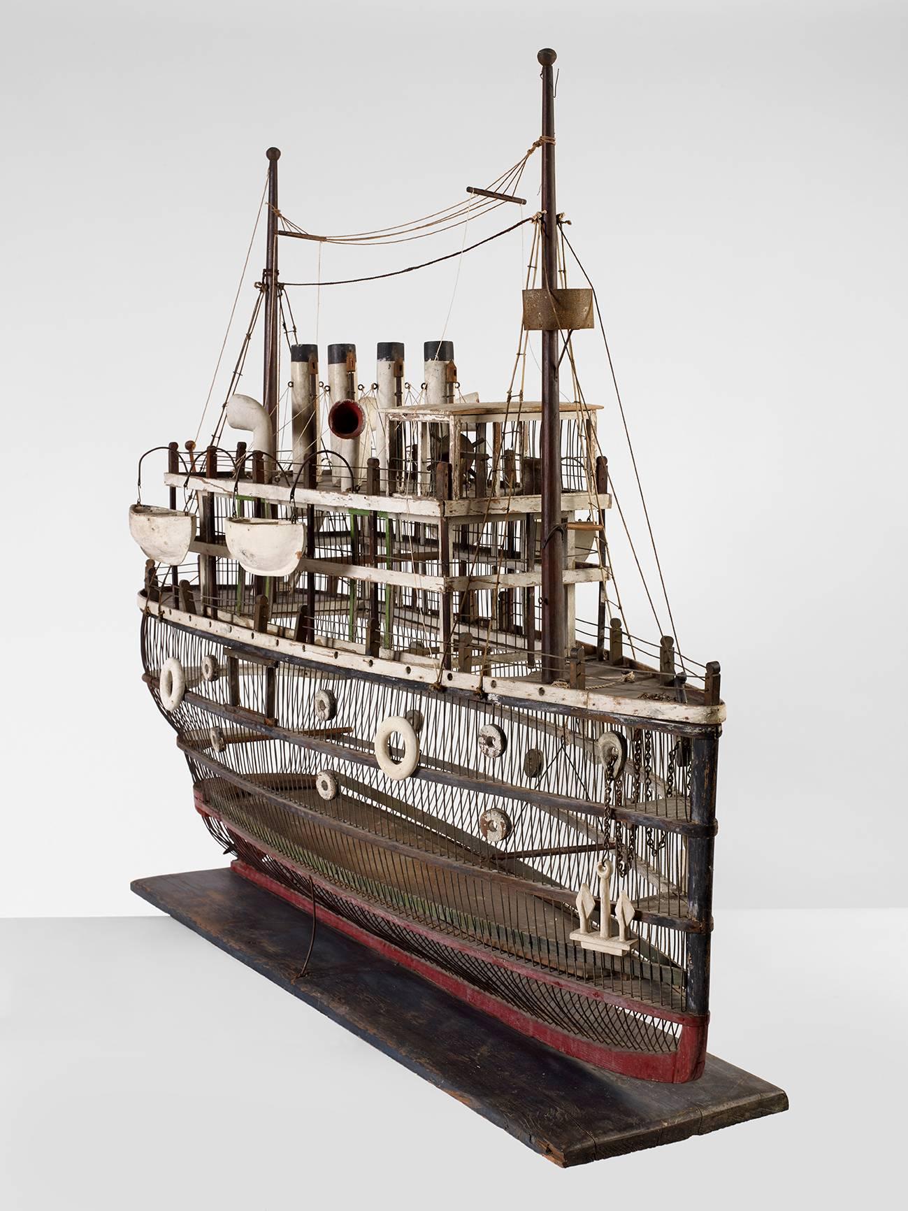 Birdcage
Four funnel ocean liner
“RMS Titanic”
American, first quarter of the 20th century
Painted wood, wire, tin, chain and string
Measure: H 45”, L 52”, W 20 ½”

An interesting, working birdcage in the form of a four funnel ocean liner,